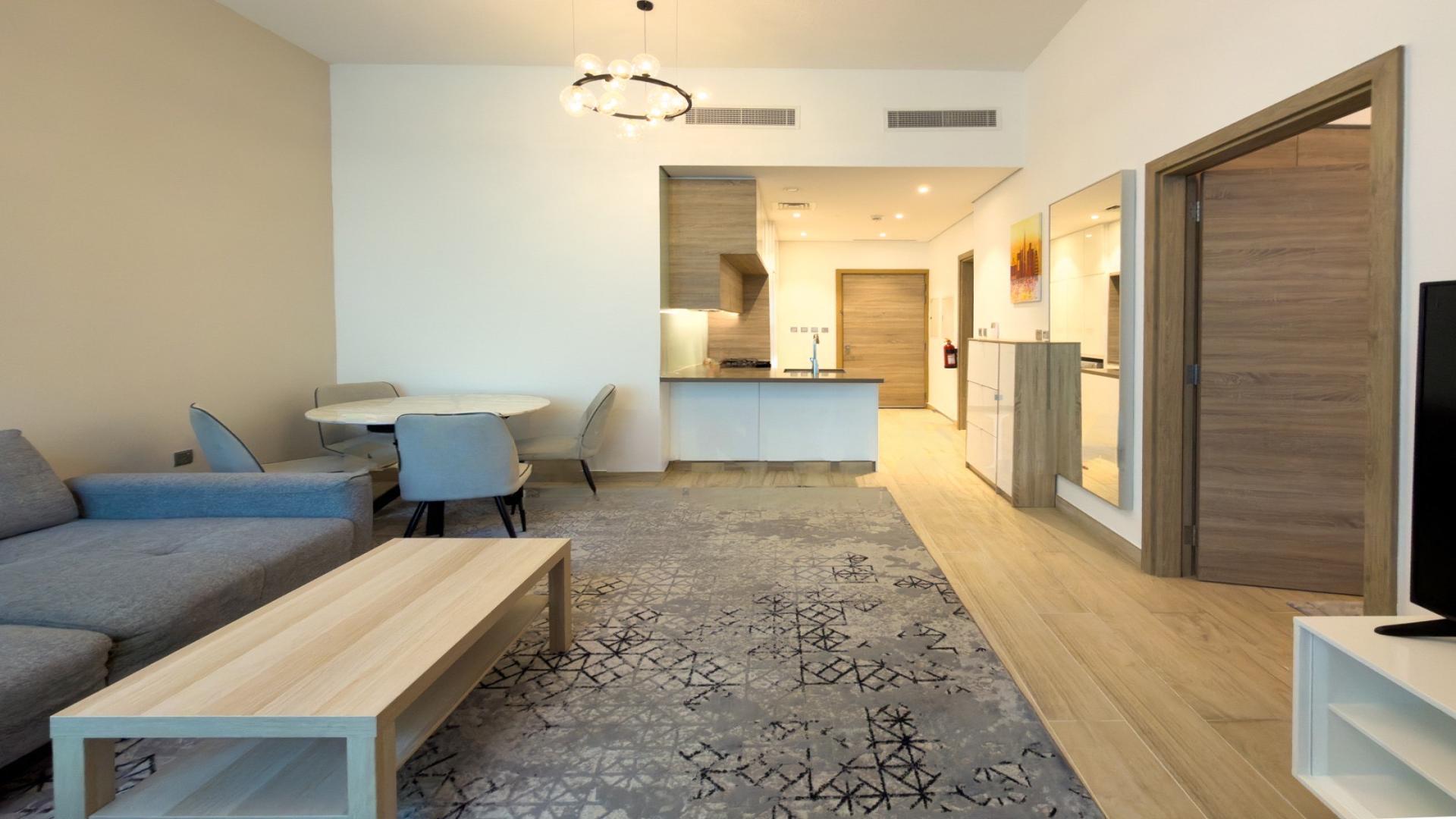 Modern living area in Studio One Tower apartment, Dubai Marina, featuring stylish furniture and kitchen