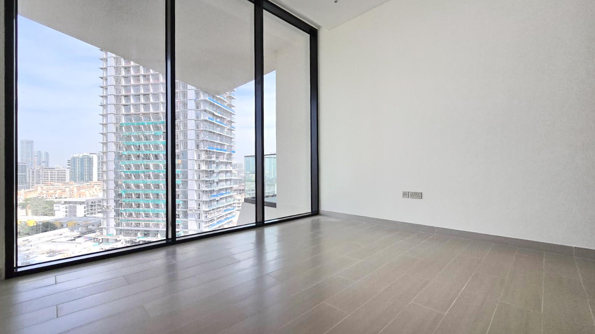 "Brand new JVC apartment balcony with private pool and city view for rent.",Brand new apartment interior with large windows, Binghatti Royale, JVC community view