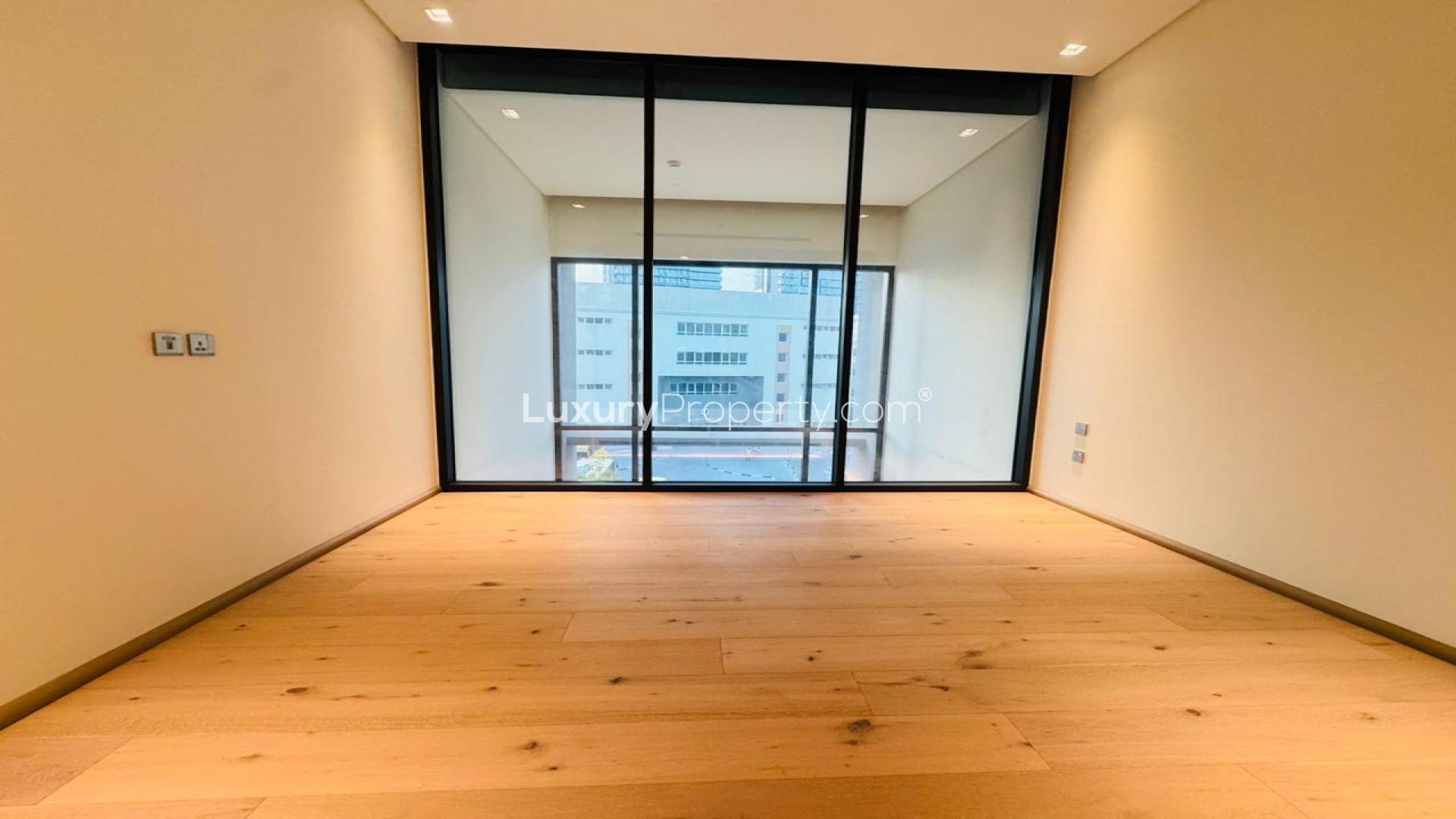 Unfurnished modern kitchen in JVC apartment for rent, featuring sleek wood cabinetry