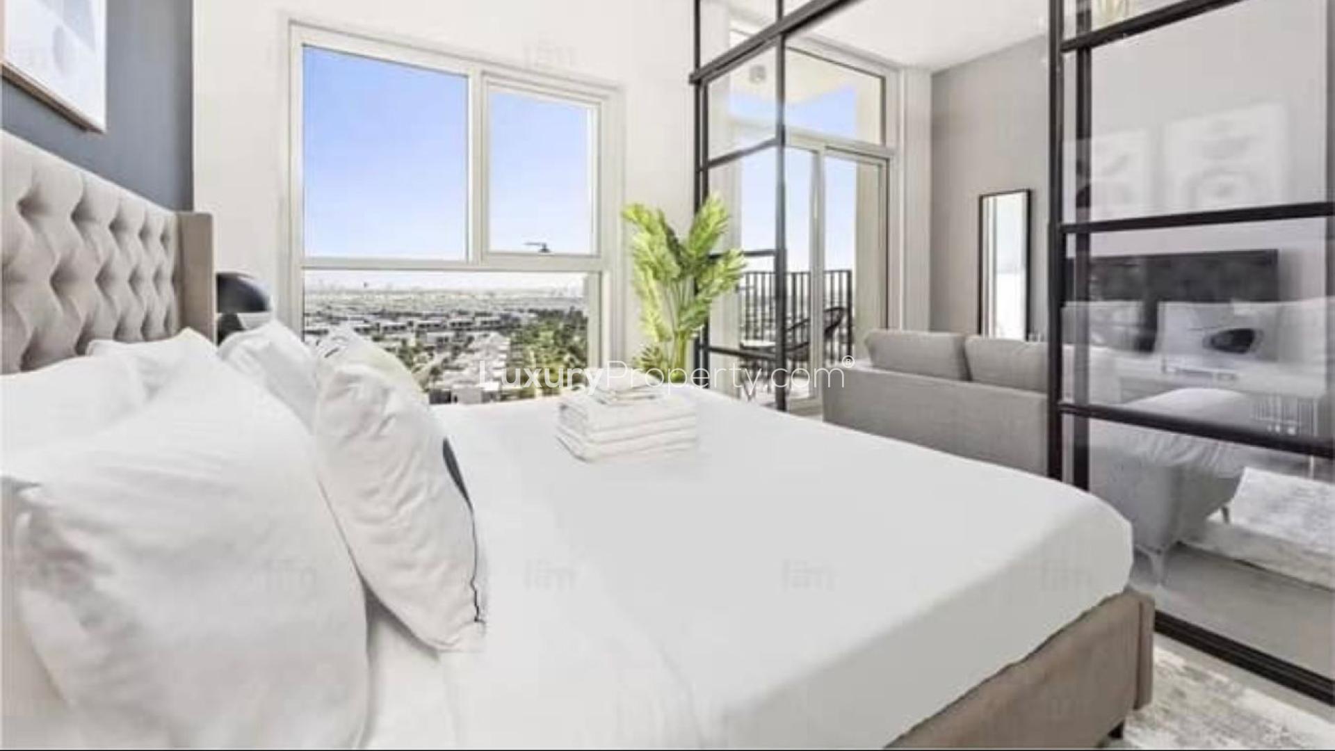 Modern living room in Dubai Hills Estate apartment, featuring sleek furniture and balcony view