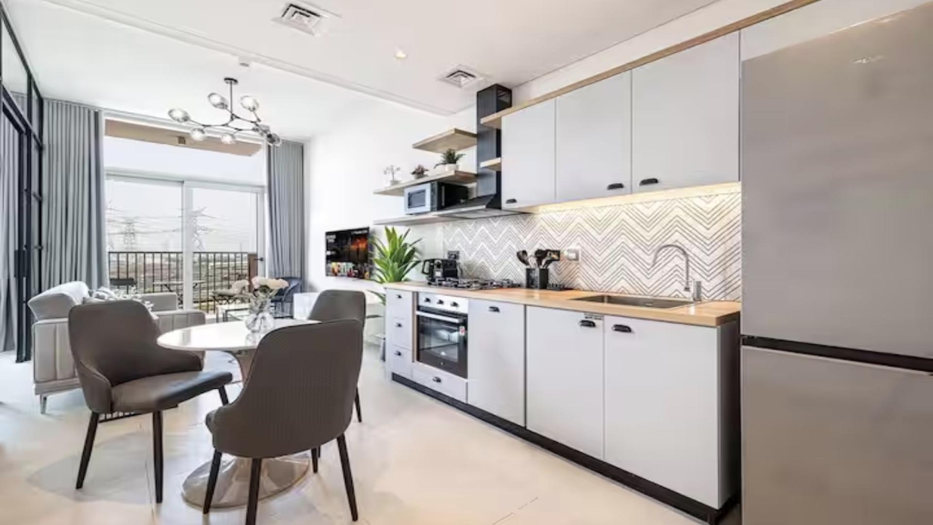 Modern living room in Dubai Hills Estate apartment with balcony view, Collective 2.0 Tower B