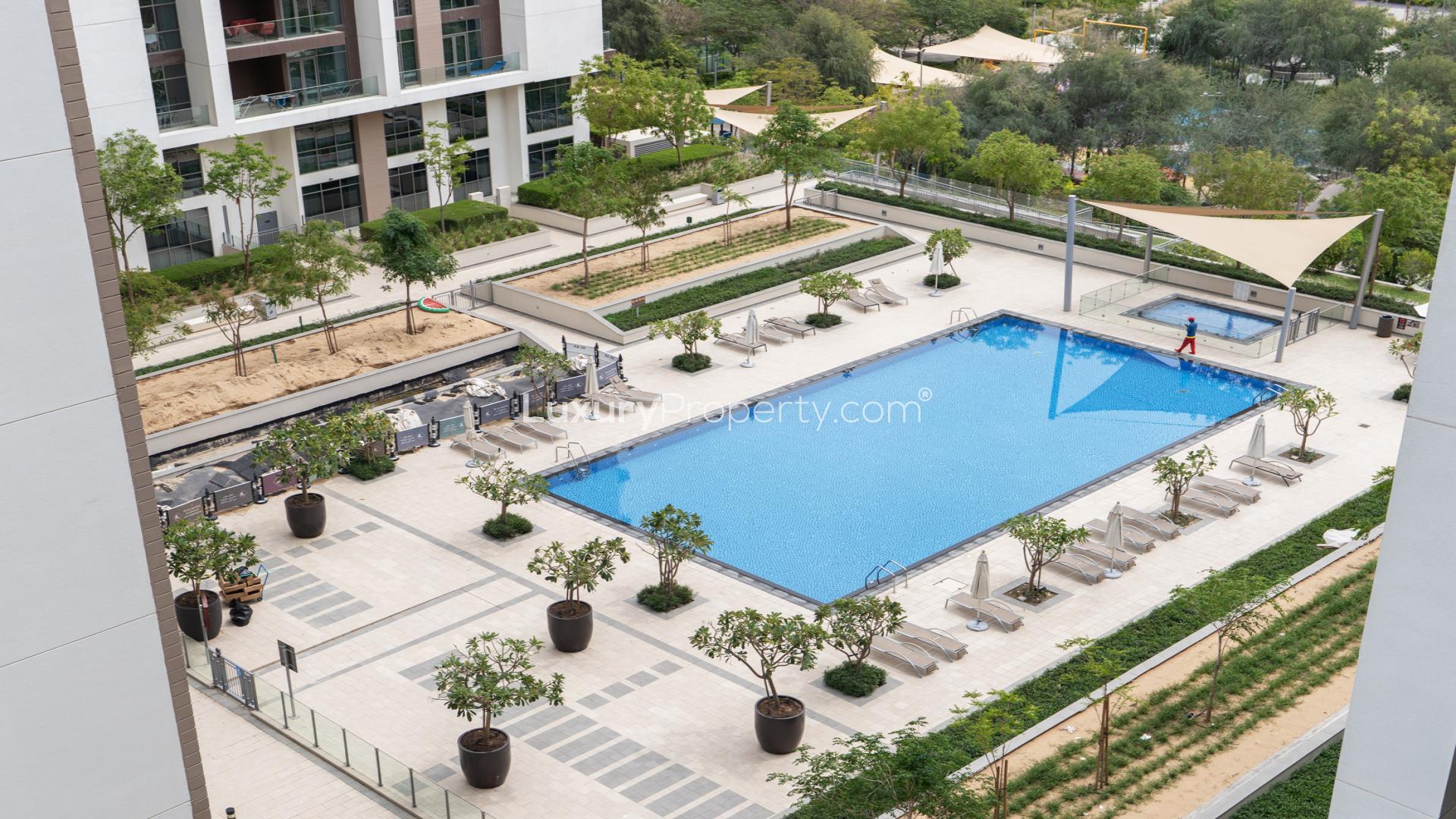 Balcony view of pool and greenery at Acacia B, Dubai Hills Estate apartment