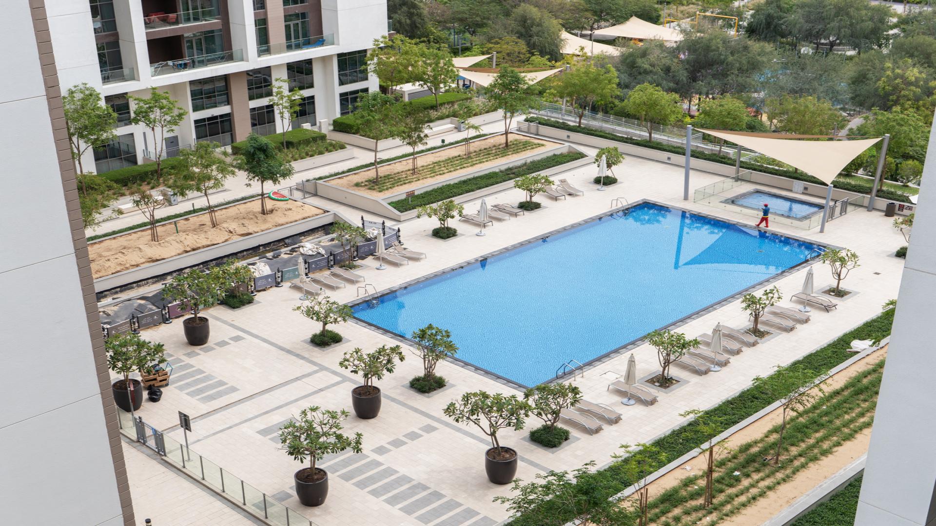 Balcony view of pool and greenery at Acacia B, Dubai Hills Estate apartment