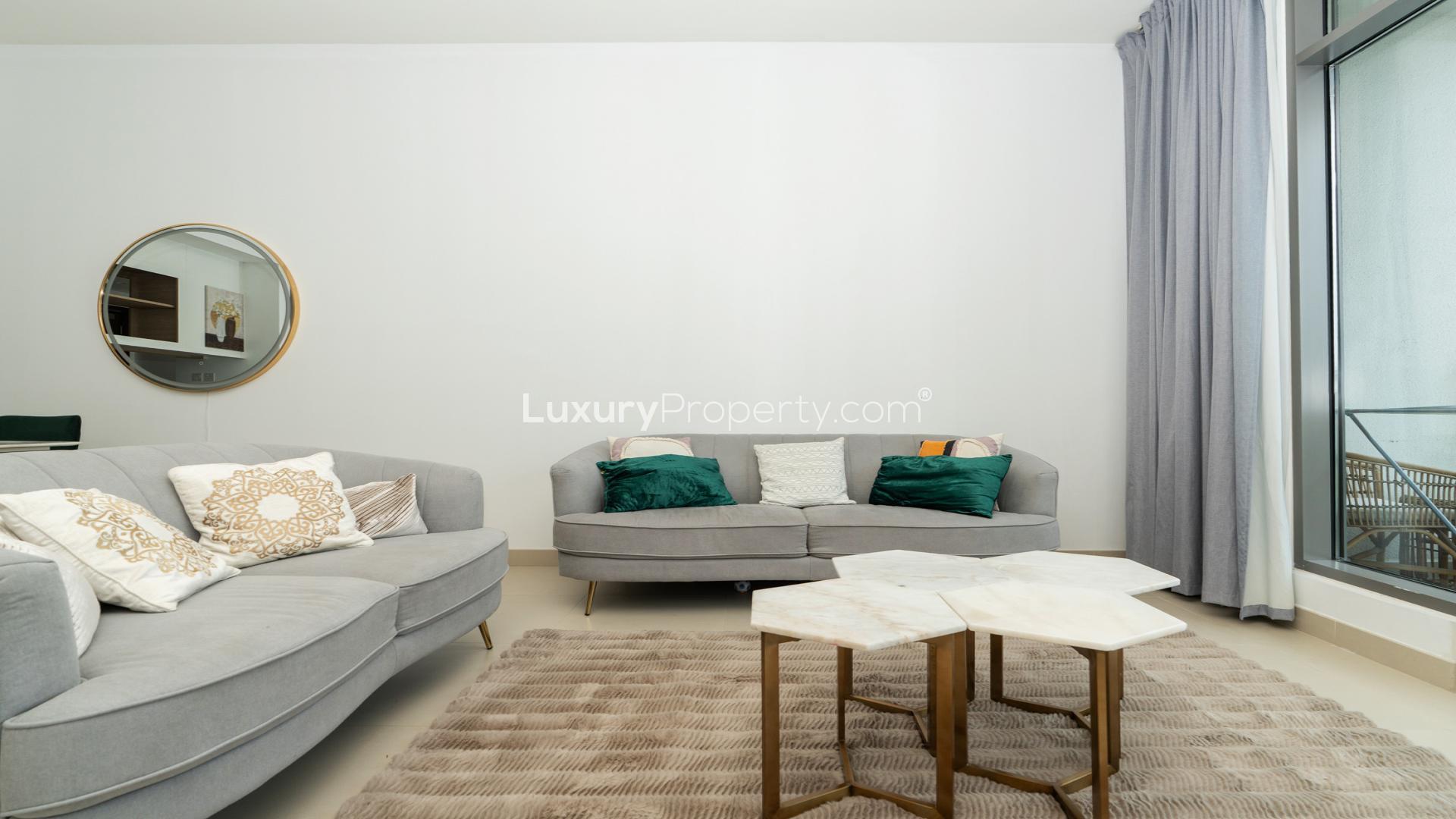 "Modern furnished living room with balcony view in Dubai Hills Estate apartment for rent.",Fully furnished living room in Acacia B apartment, Dubai Hills Estate, with modern decor
