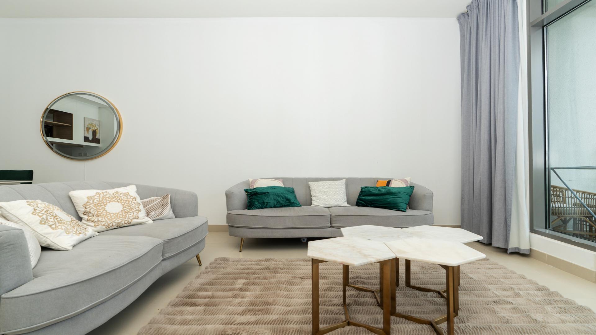 "Modern furnished living room with balcony view in Dubai Hills Estate apartment for rent.",Fully furnished living room in Acacia B apartment, Dubai Hills Estate, with modern decor