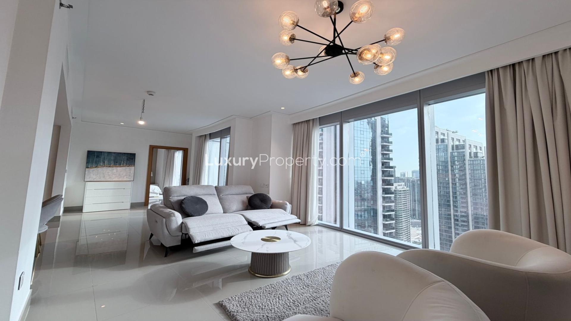 Modern Downtown Dubai apartment living room with city view, elegant decor, and large windows