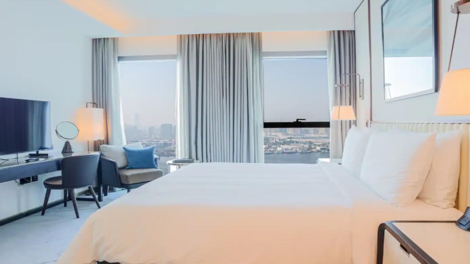 Modern living room with TV in Creek Beach apartment, Address Residences Dubai Creek Harbour