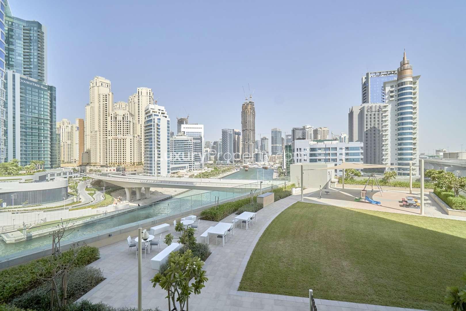 Waterfront view from 1-bedroom apartment in 52|42, Dubai Marina, with lush outdoor space