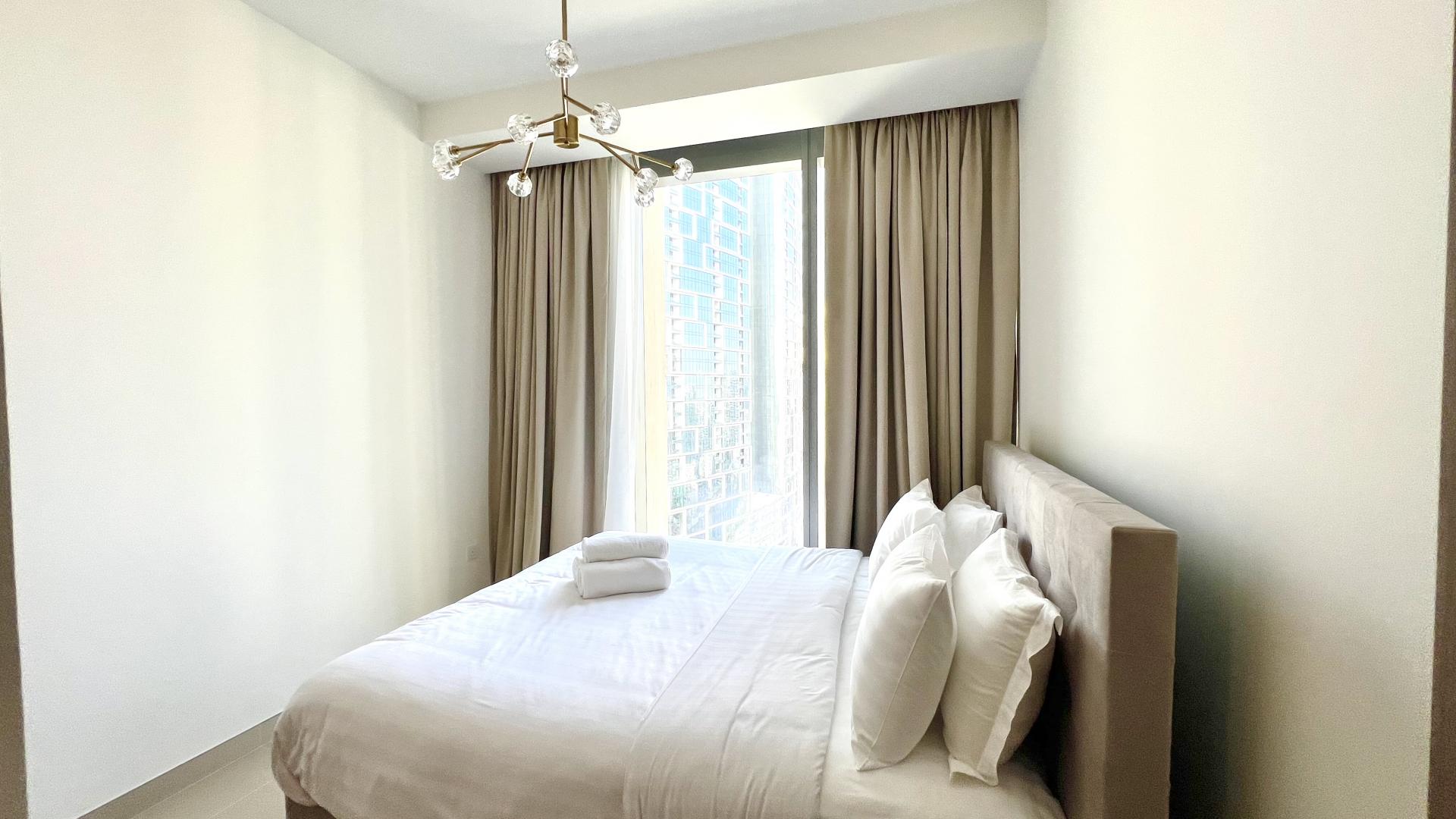 Modern kitchen in furnished Dubai Marina apartment, featuring sleek cabinetry and appliances