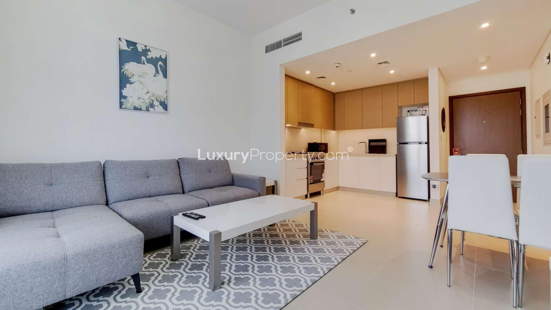 Modern living room in Dubai Marina apartment with balcony view of Ain Dubai