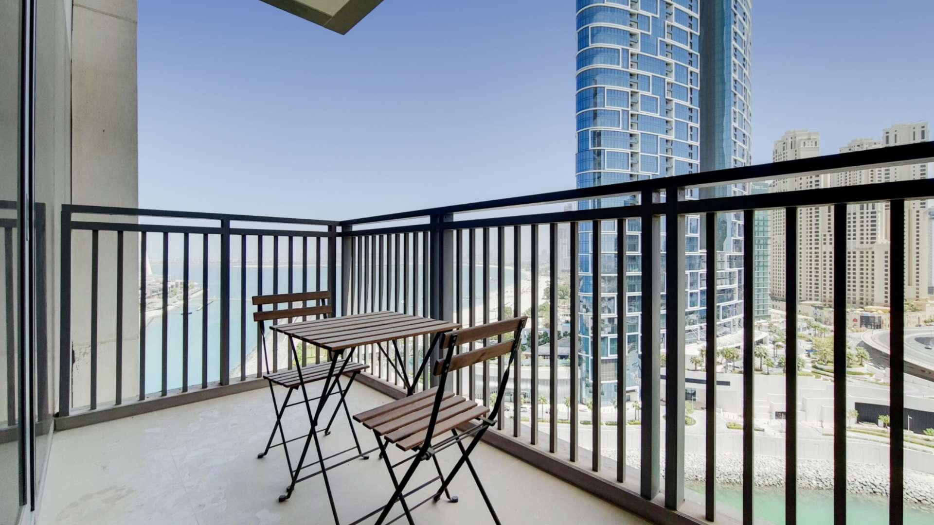 "Modern living room and kitchen in Dubai Marina one-bedroom apartment for rent, LP15894.",Balcony view from one-bedroom apartment in Dubai Marina, overlooking Ain Dubai and skyline