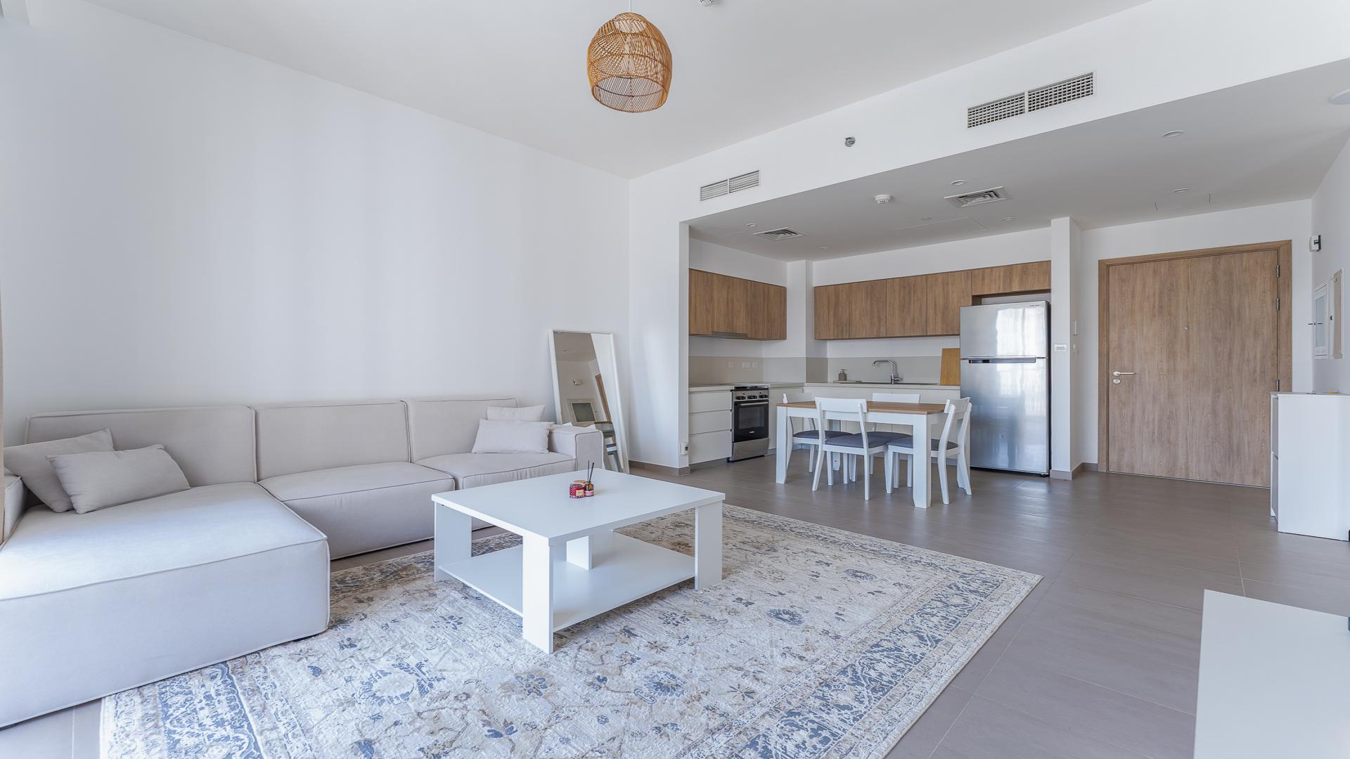 Bright living room with balcony view in Park Ridge, Dubai Hills Estate apartment for rent