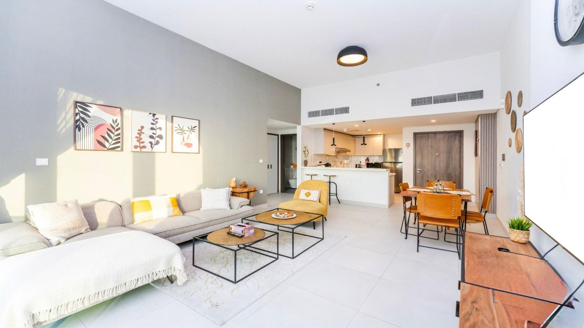 Modern Al Kifaf apartment interior with city view, featuring dining area and cozy living space