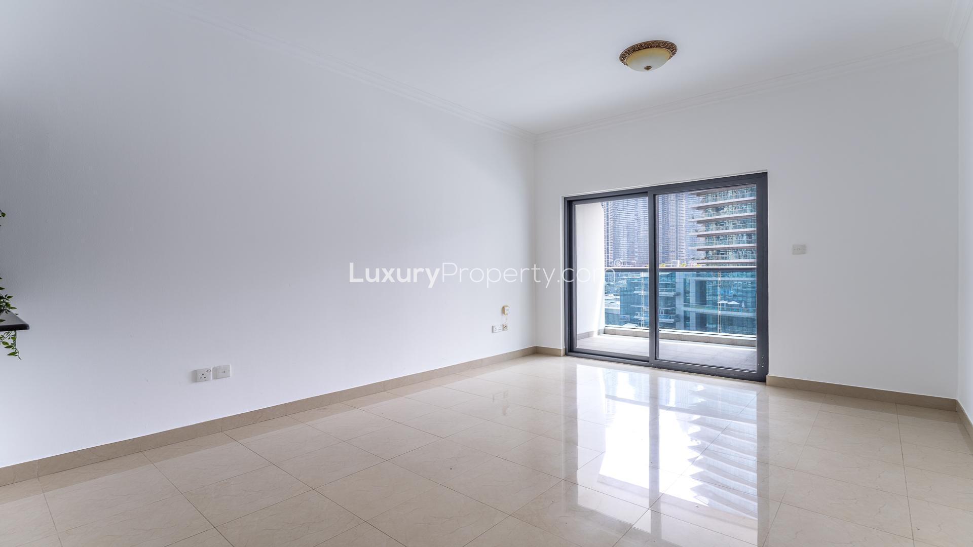Empty living room in Time Place Tower apartment, Dubai Marina, with tiled flooring