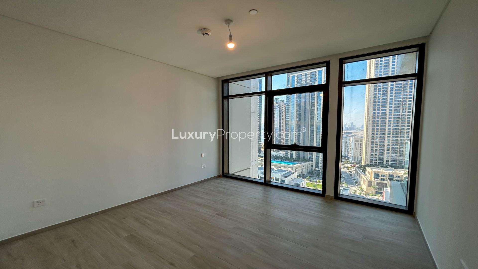 Modern 1-bedroom apartment interior with kitchen and large windows in Palace Residences, Dubai Creek