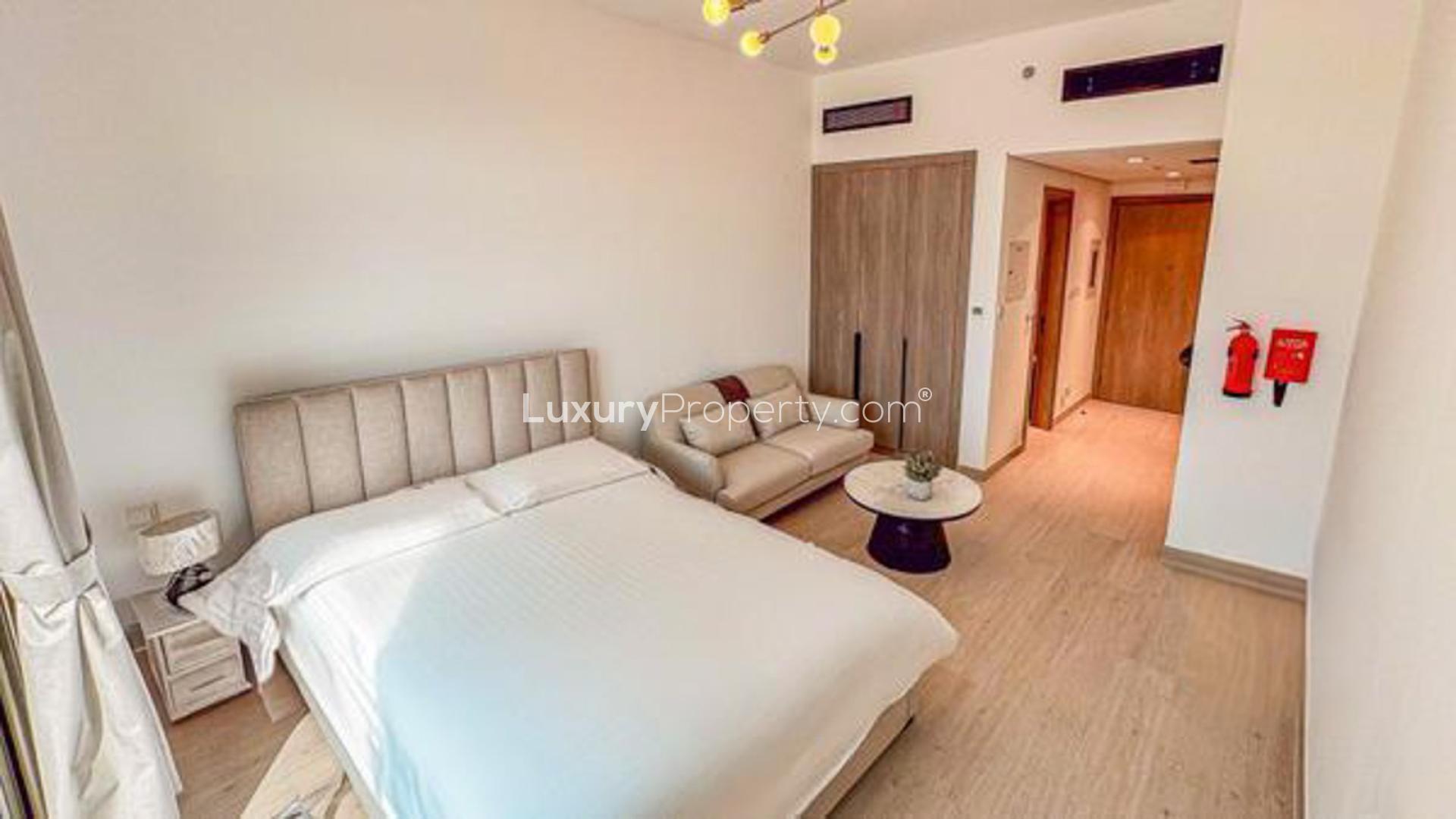 Reception area of Laya Heights apartment, Dubai Studio City, marble counter and decorative shelves