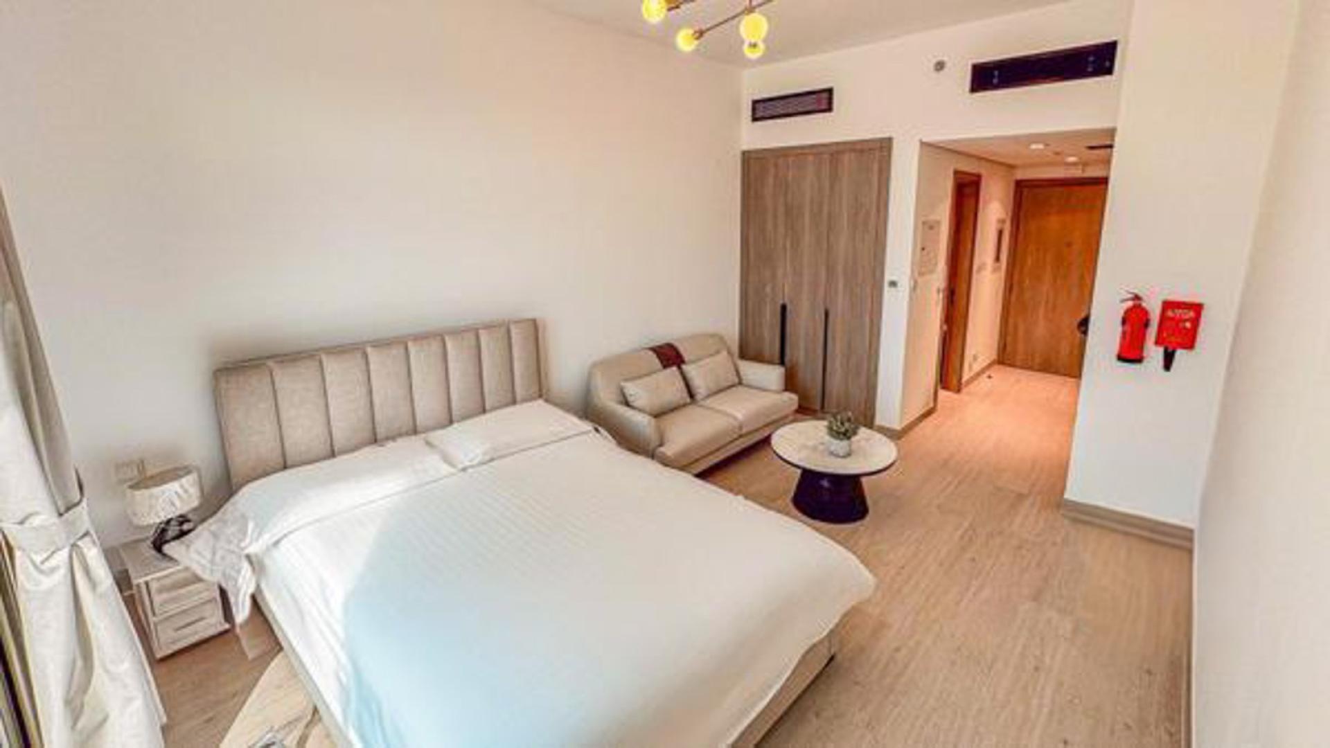 Reception area of Laya Heights apartment, Dubai Studio City, marble counter and decorative shelves