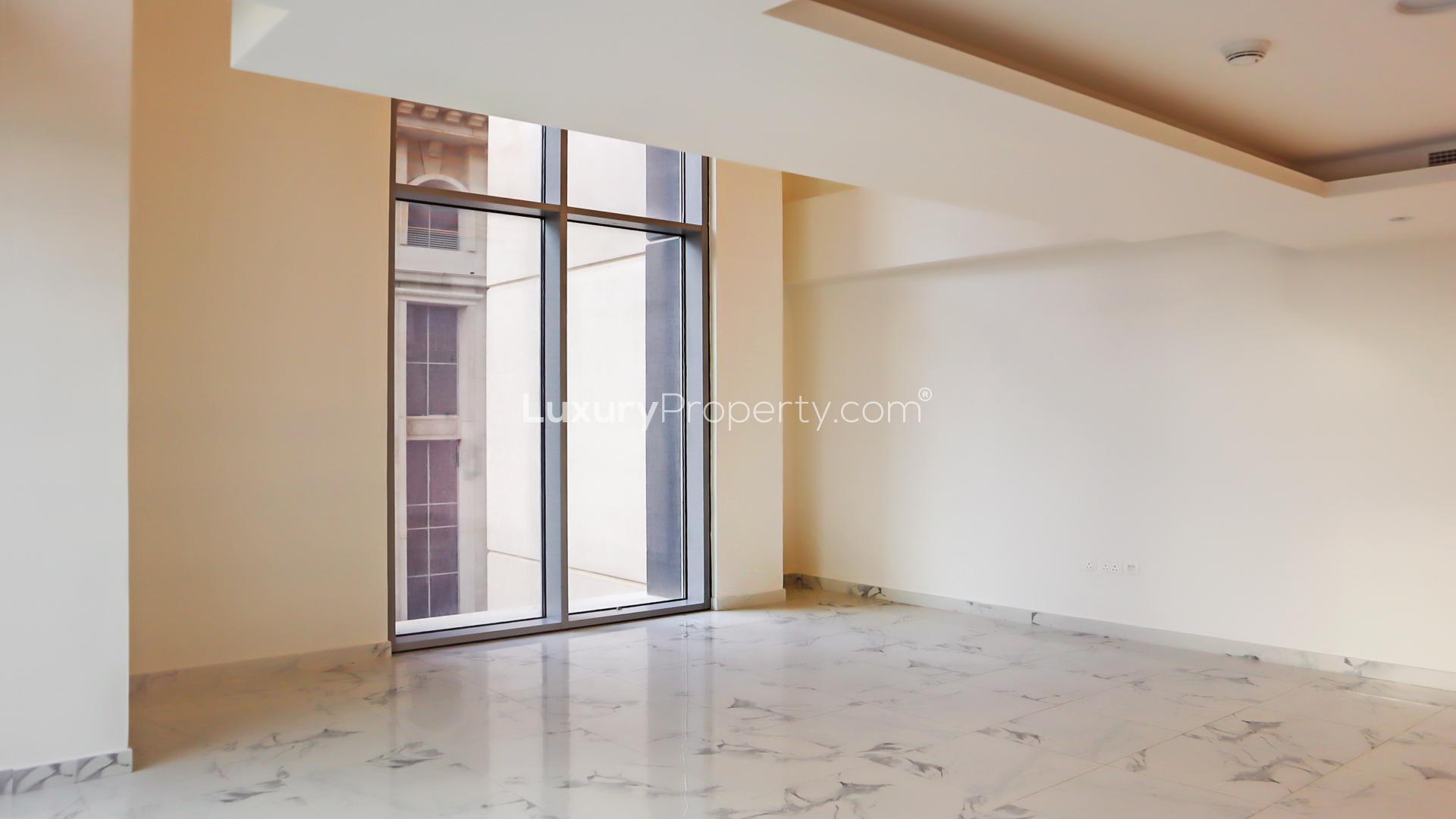 Spacious modern loft-style apartment interior with large windows in Al Habtoor City