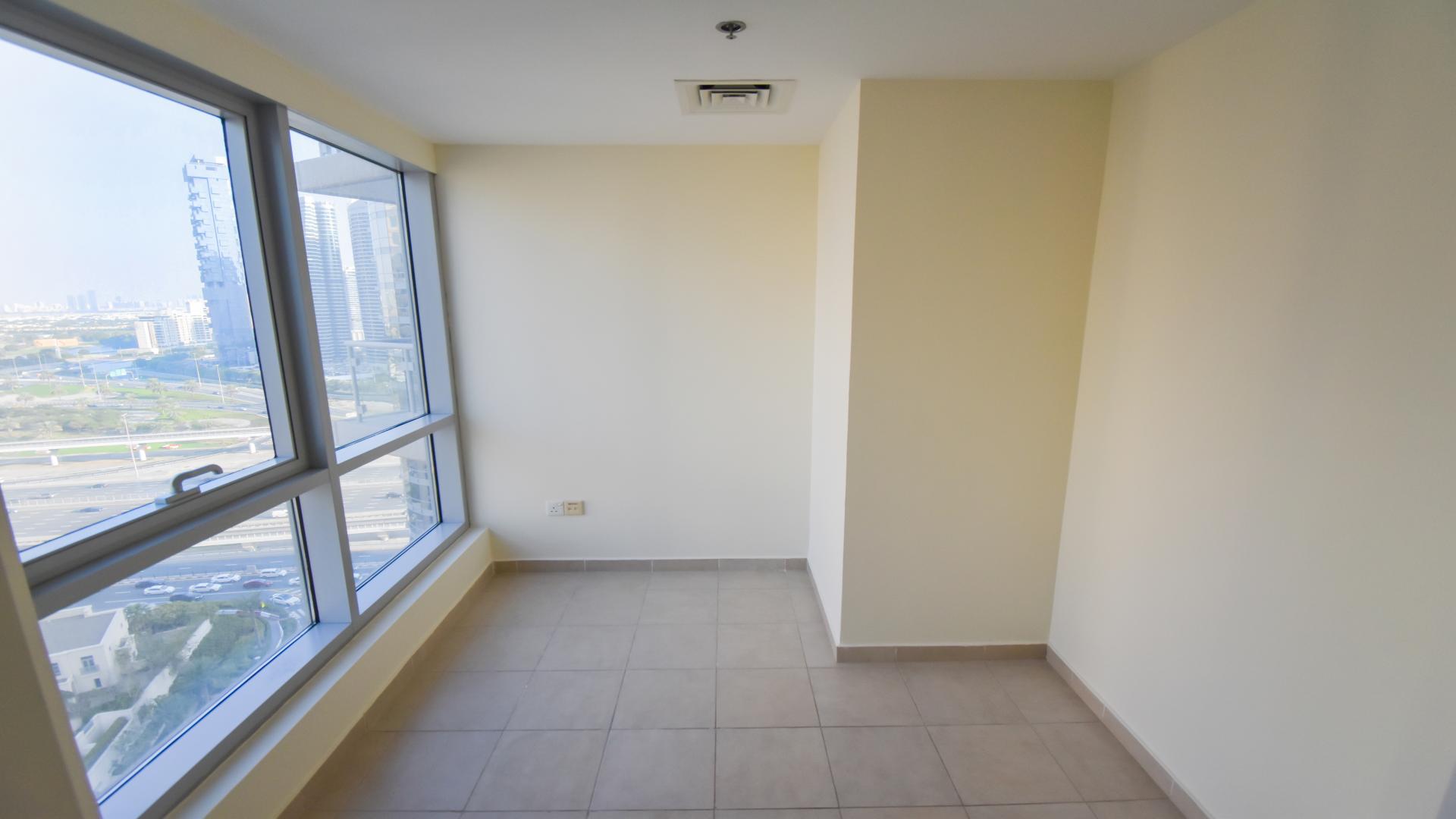 Spacious living area in Al Habtoor City apartment, Business Bay, with marina skyline view