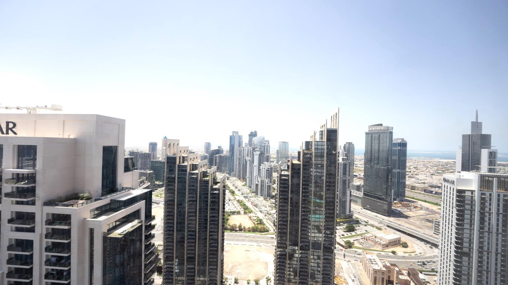Empty modern apartment with large windows offering stunning Downtown Dubai skyline views