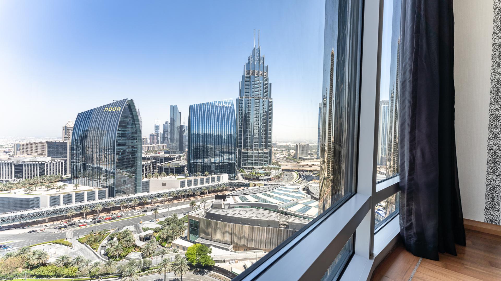 Studio apartment interior with modern furnishings and Burj Khalifa views in Downtown Dubai