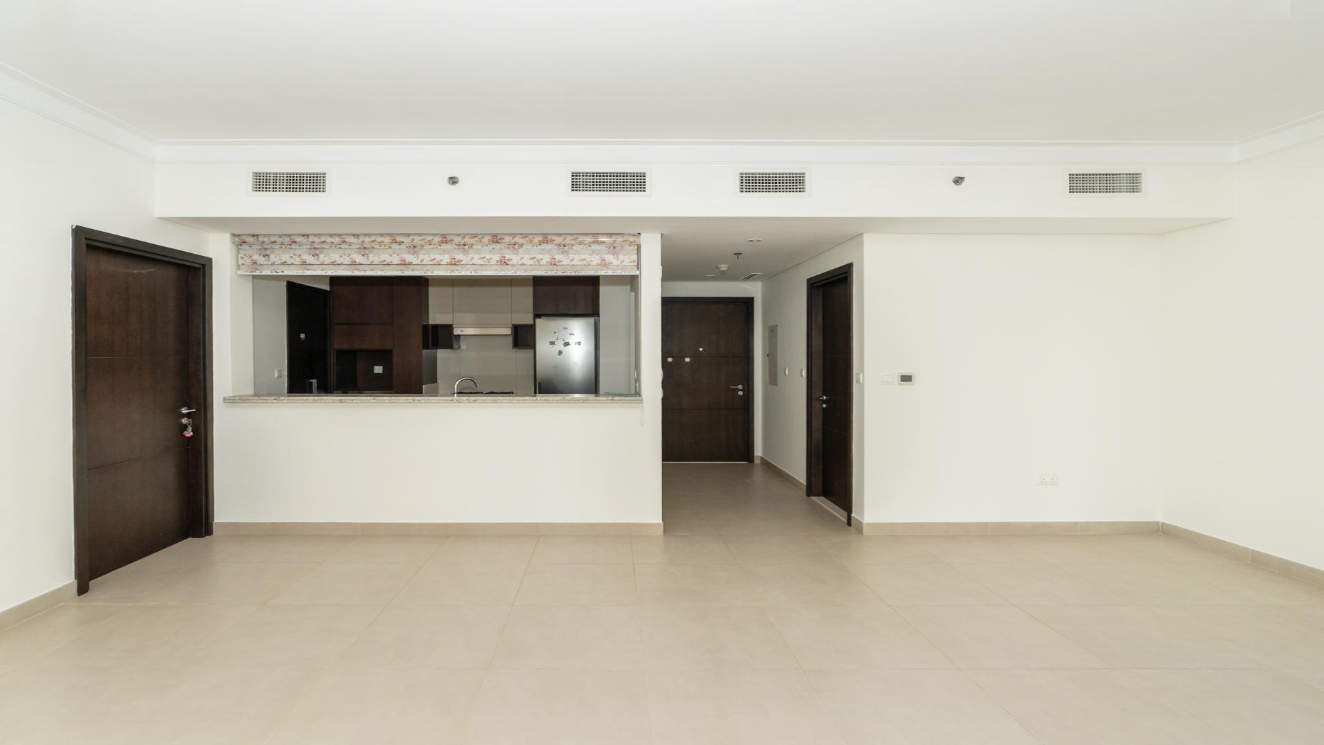 Modern living room in Dubai Creek Harbour apartment with large windows and stylish decor