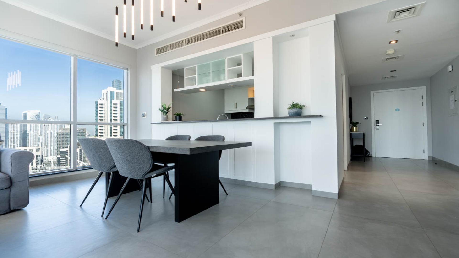 Spacious furnished apartment in Downtown Dubai with city views, modern dining area, high floor