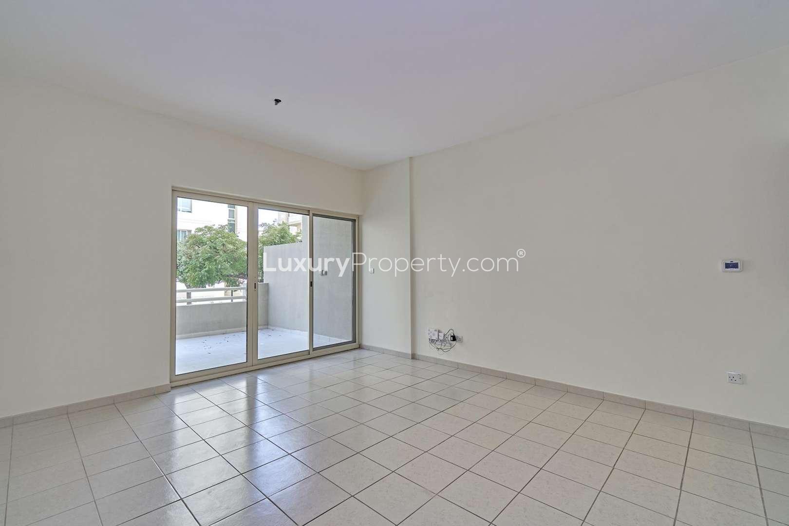 Spacious living room with large windows in Al Samar apartment, The Greens