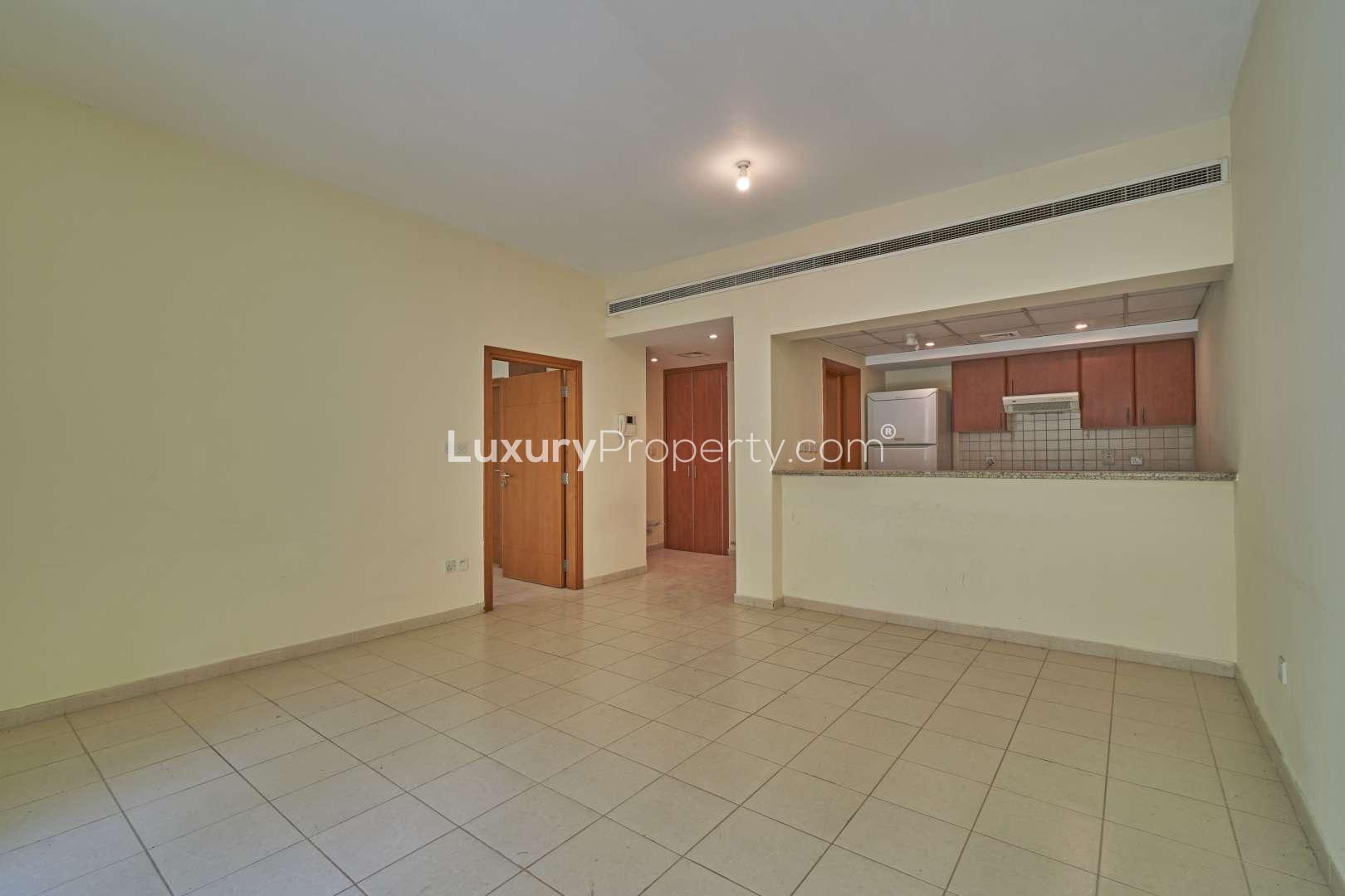 Spacious living room with balcony view in Al Samar apartment, The Greens