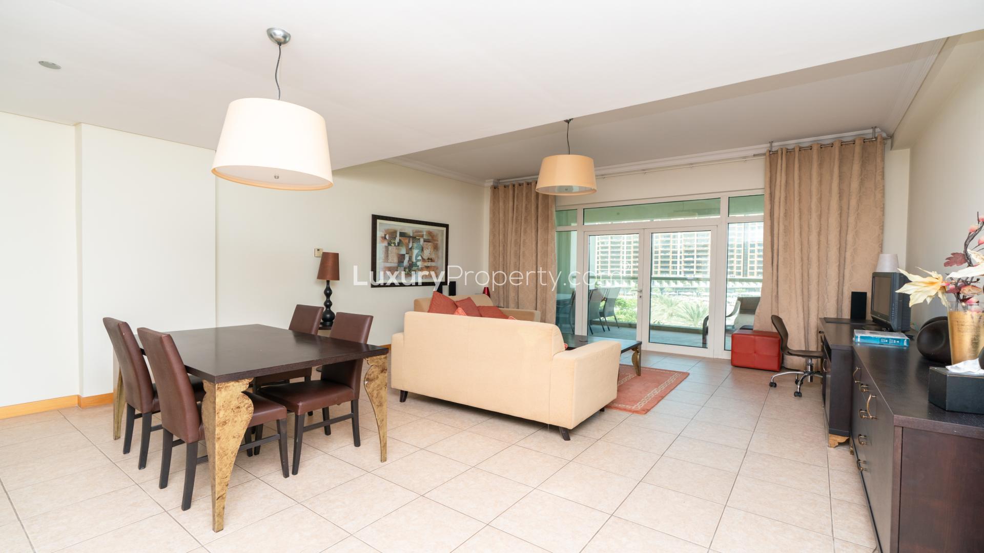 Living room of beachfront 1-bedroom apartment in Al Nabat, Palm Jumeirah, with balcony view