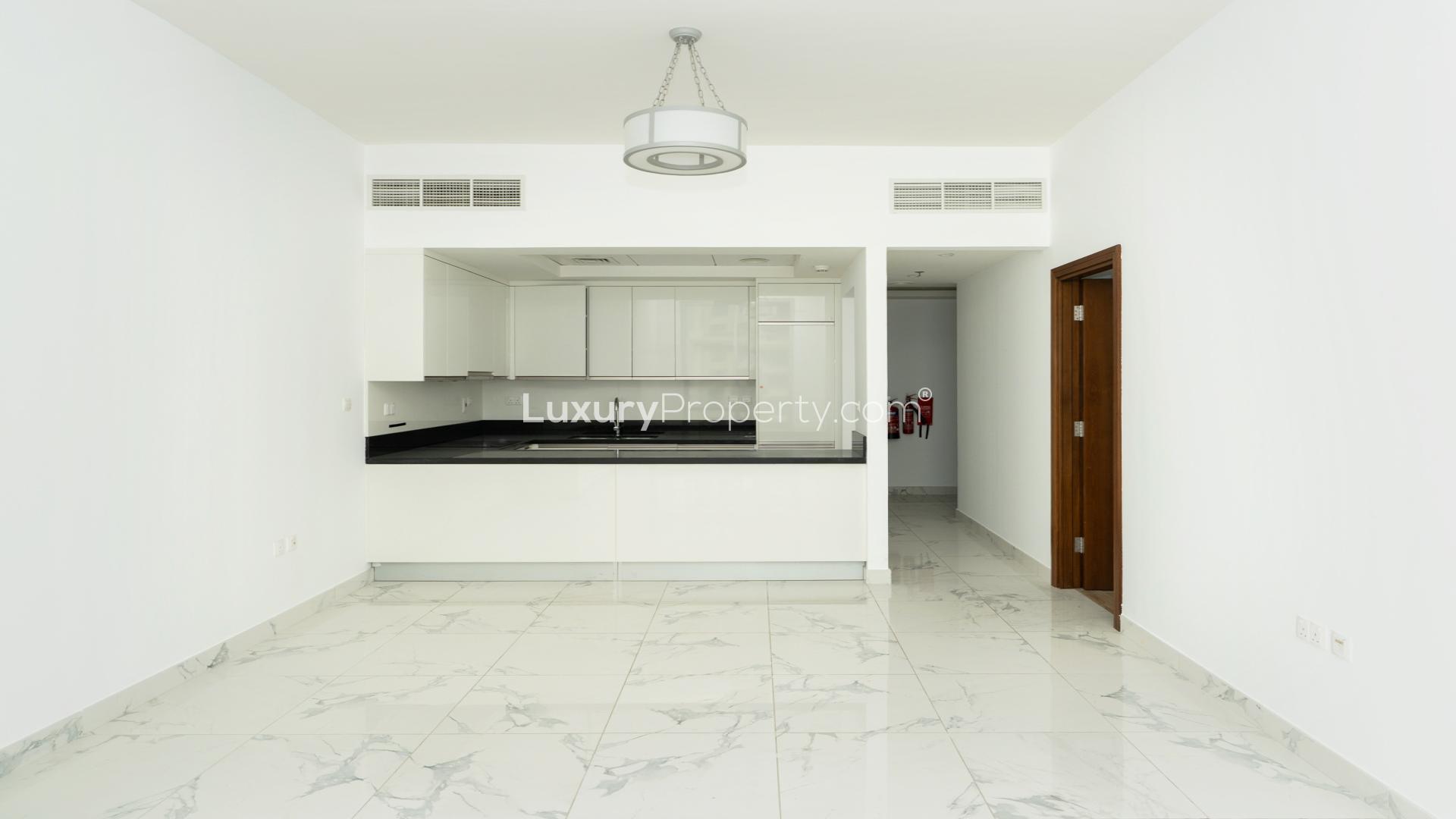 Spacious living area with modern kitchen in 1-bedroom apartment, Noura Tower, Business Bay