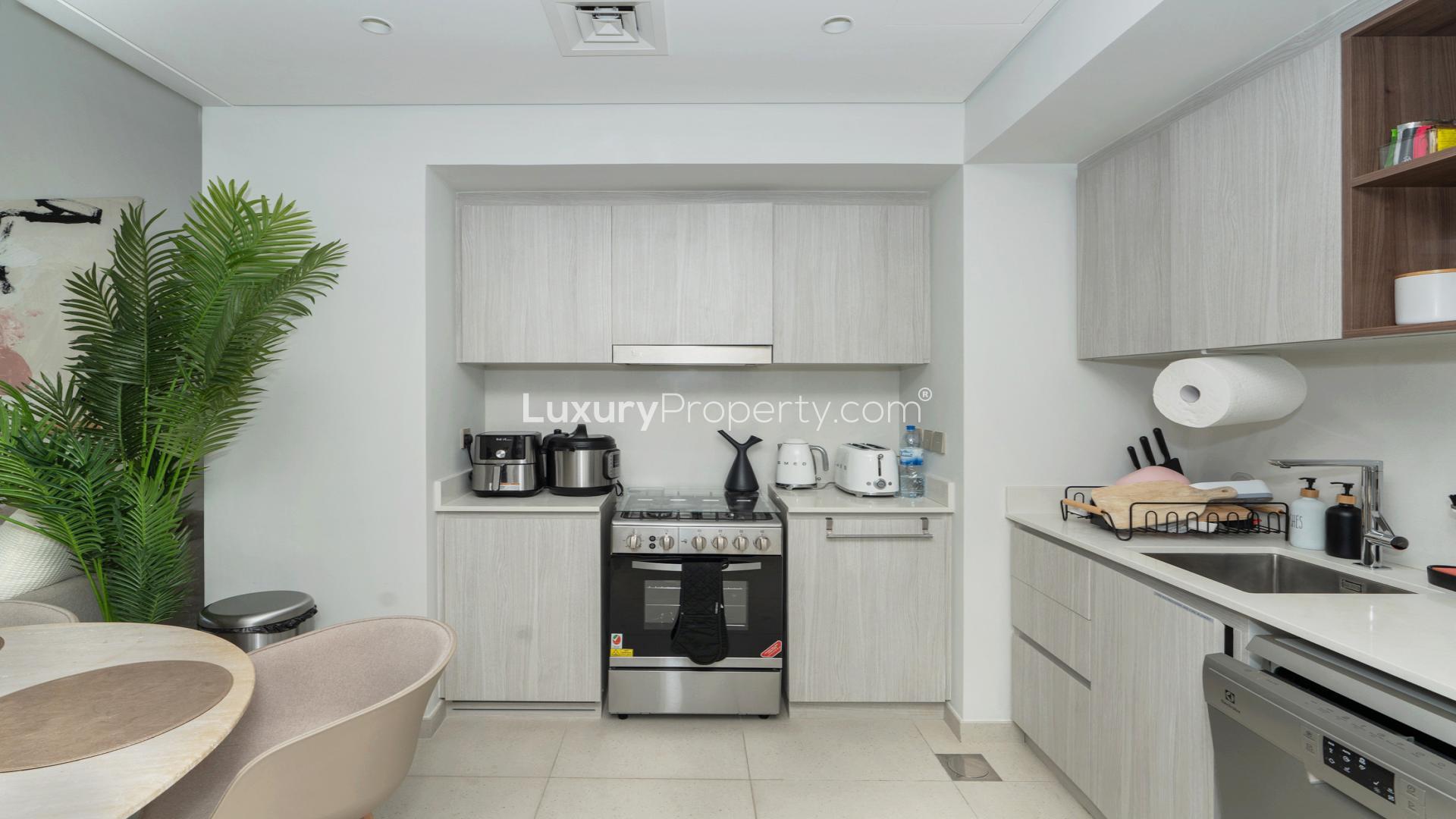 Modern kitchen in 1-bedroom apartment, Dubai Creek Harbour, featuring sleek appliances and cabinetry