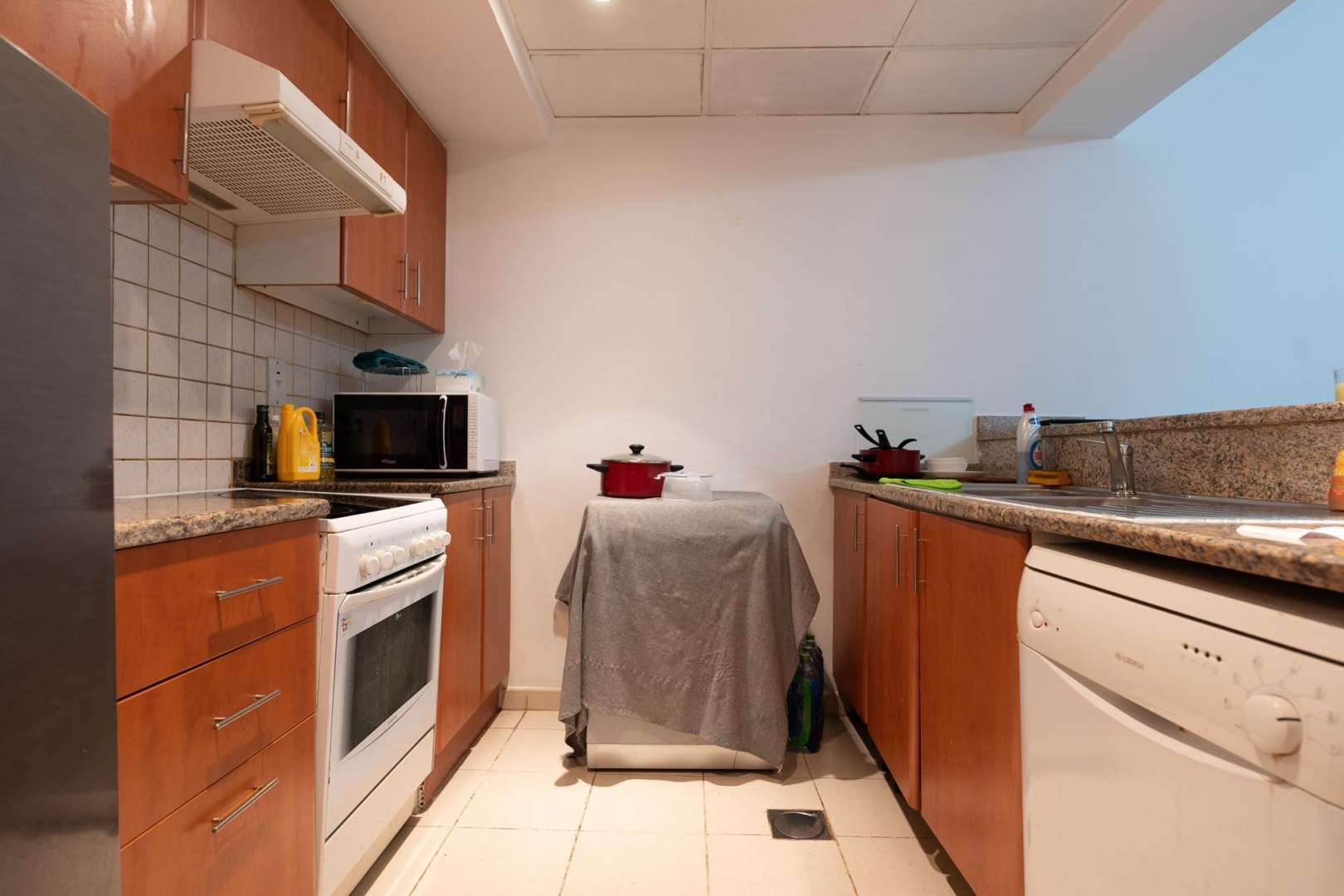 Modern living room in 1-bedroom apartment, Al Thayyal, The Greens, featuring sleek furnishings