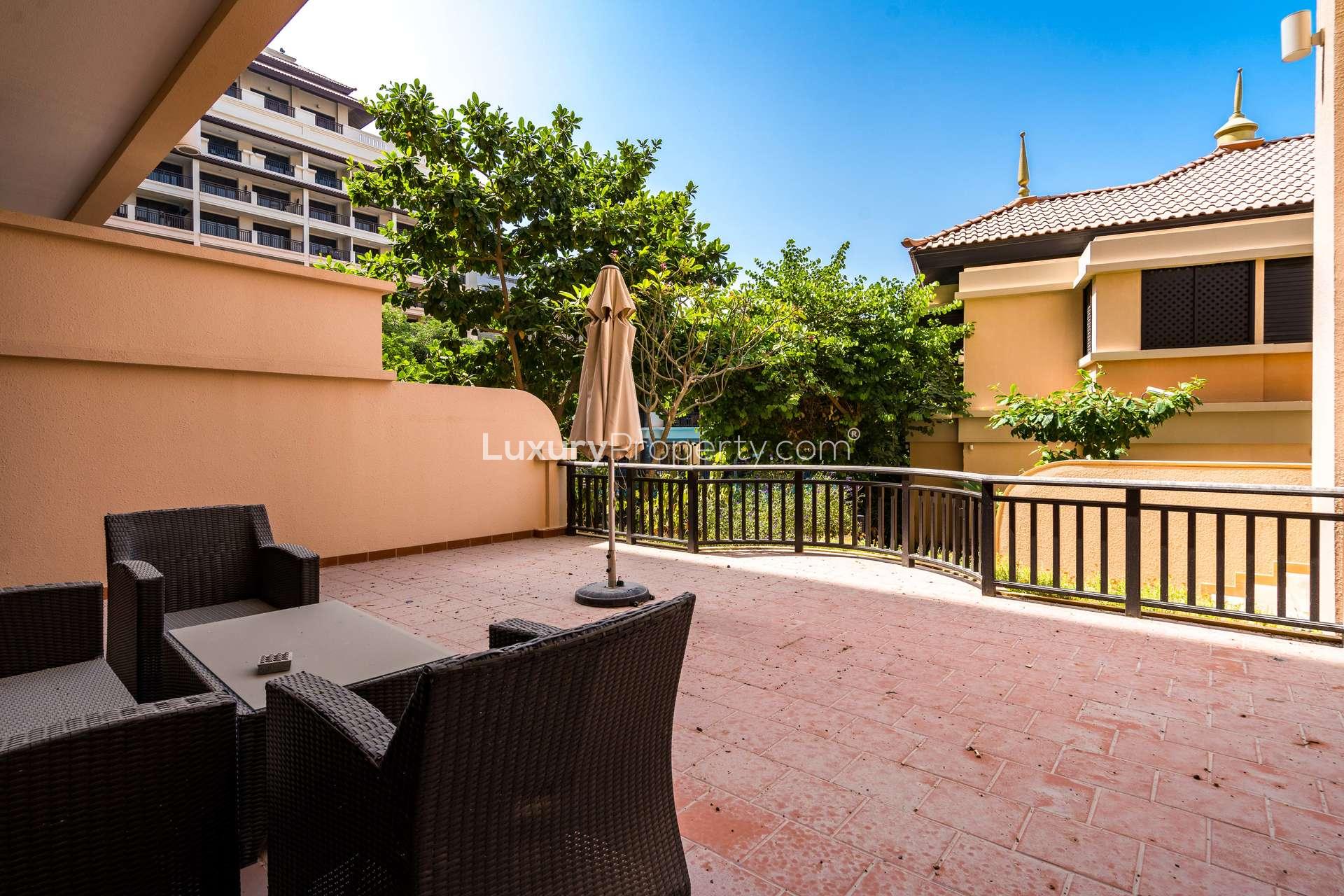 Modern kitchen with dark wood cabinets in Palm Jumeirah apartment, Anantara Residences