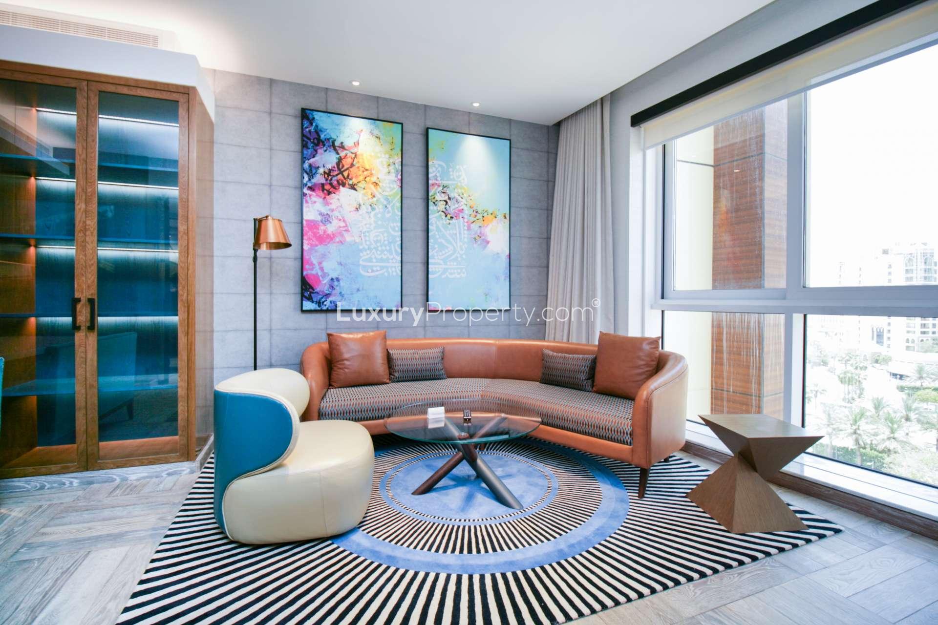 Stylish bedroom in Andaz the Palm apartment, featuring modern decor and large windows