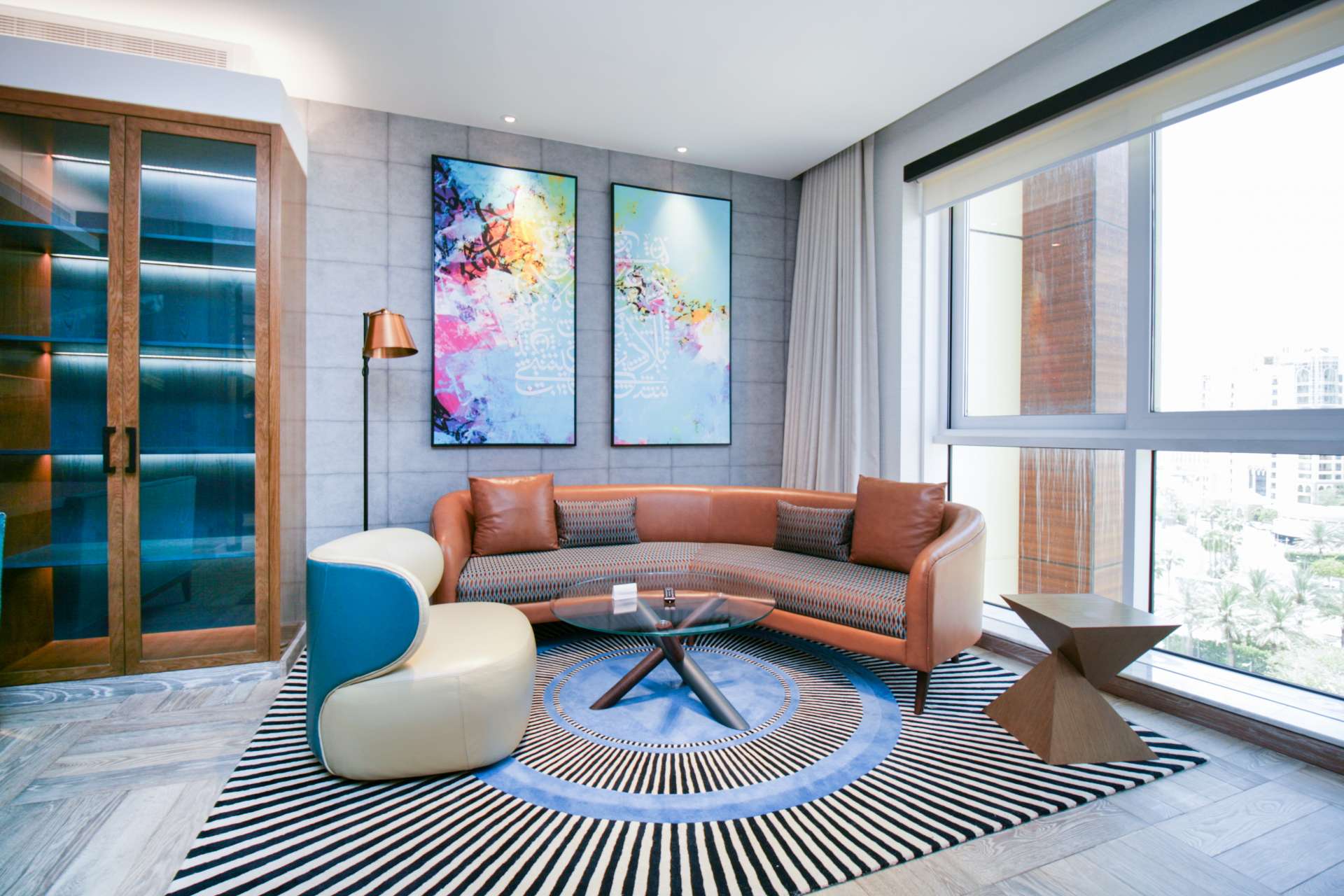 Stylish bedroom in Andaz the Palm apartment, featuring modern decor and large windows