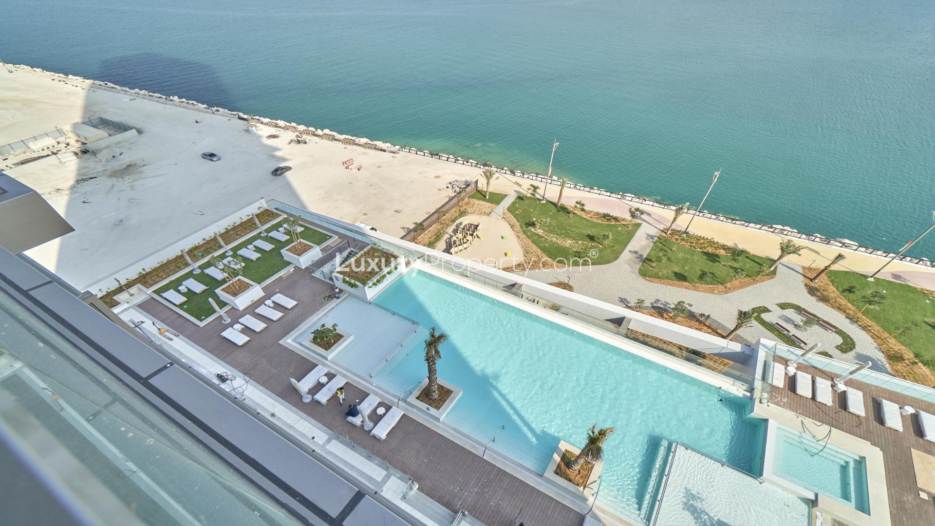 Balcony view of sea and cityscape from modern apartment in Anwa, Maritime City