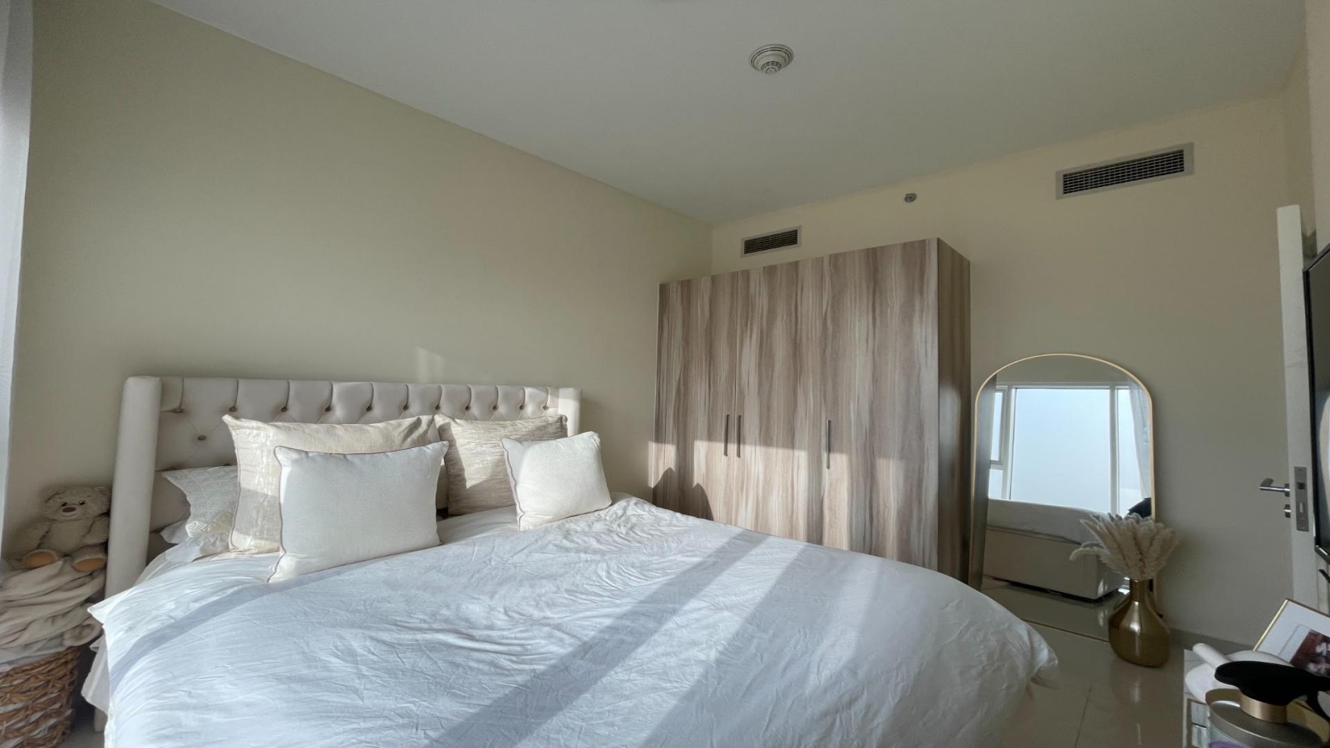 Apartment balcony with panoramic golf course view in Damac Hills, Golf Vita community