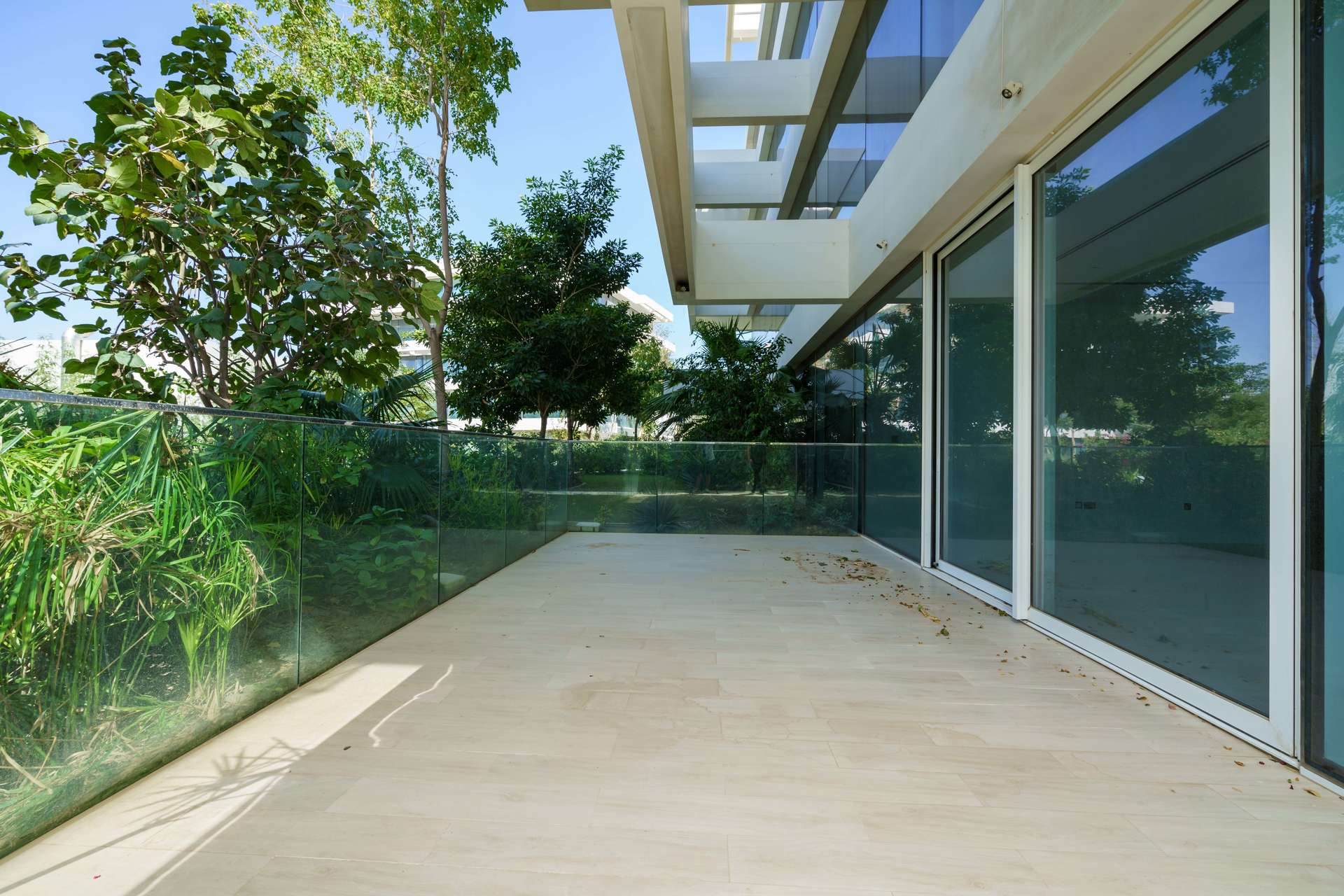 Spacious modern kitchen with large windows in luxury Ashjar apartment, Al Barari for rent