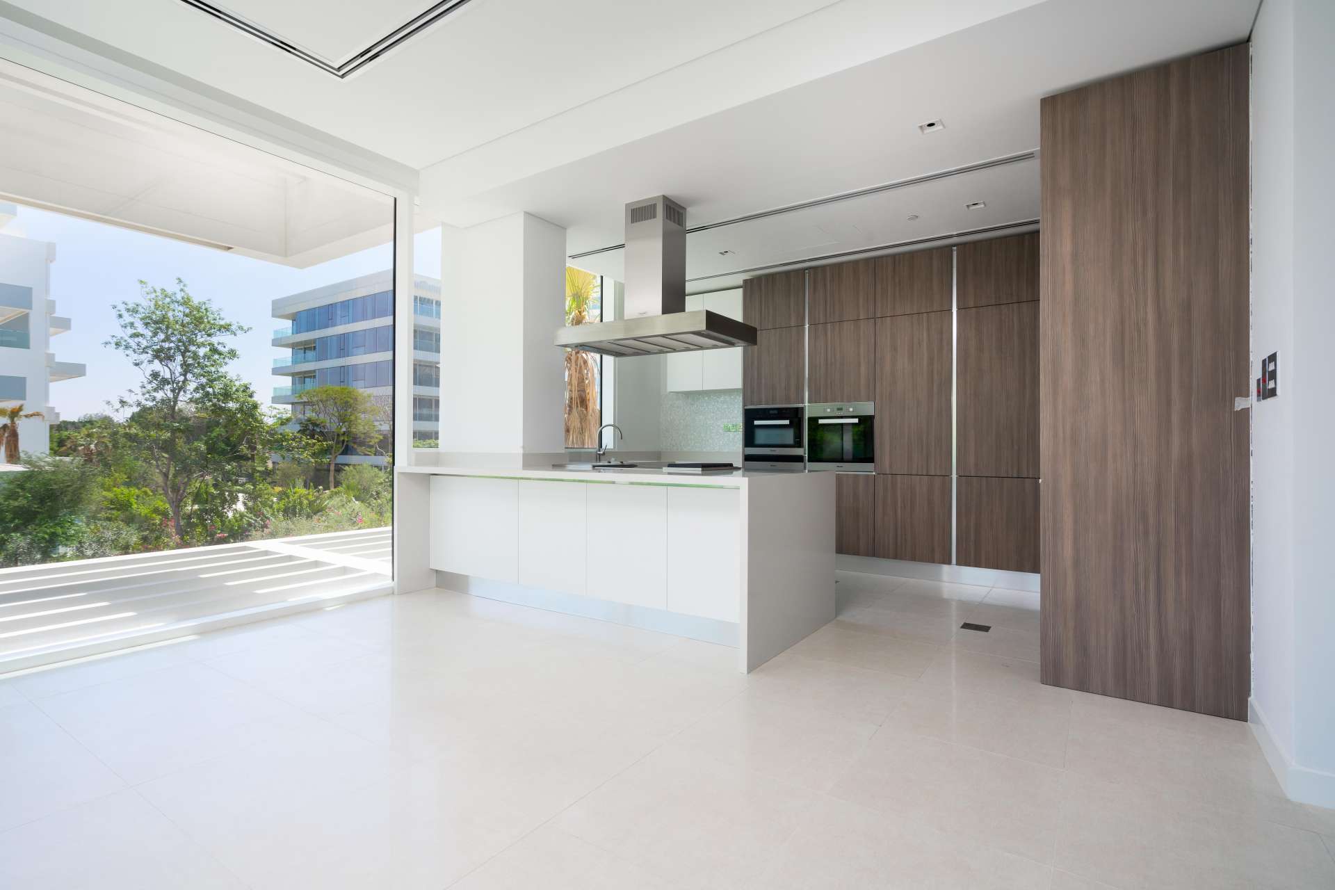 Spacious balcony view from 1-bedroom apartment in Ashjar, Al Barari, surrounded by greenery