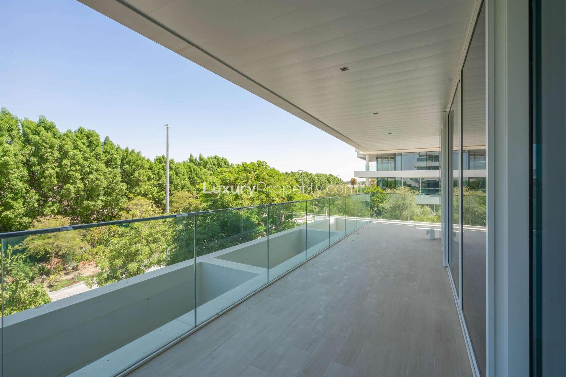 Modern kitchen in 1-bedroom Ashjar apartment, Al Barari, featuring sleek design and large windows