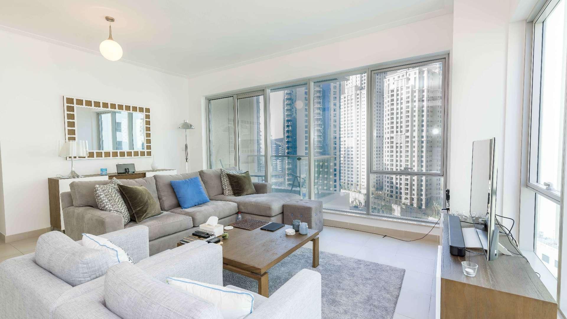 Modern living room with sea view in Dubai Marina apartment, spacious seating area
