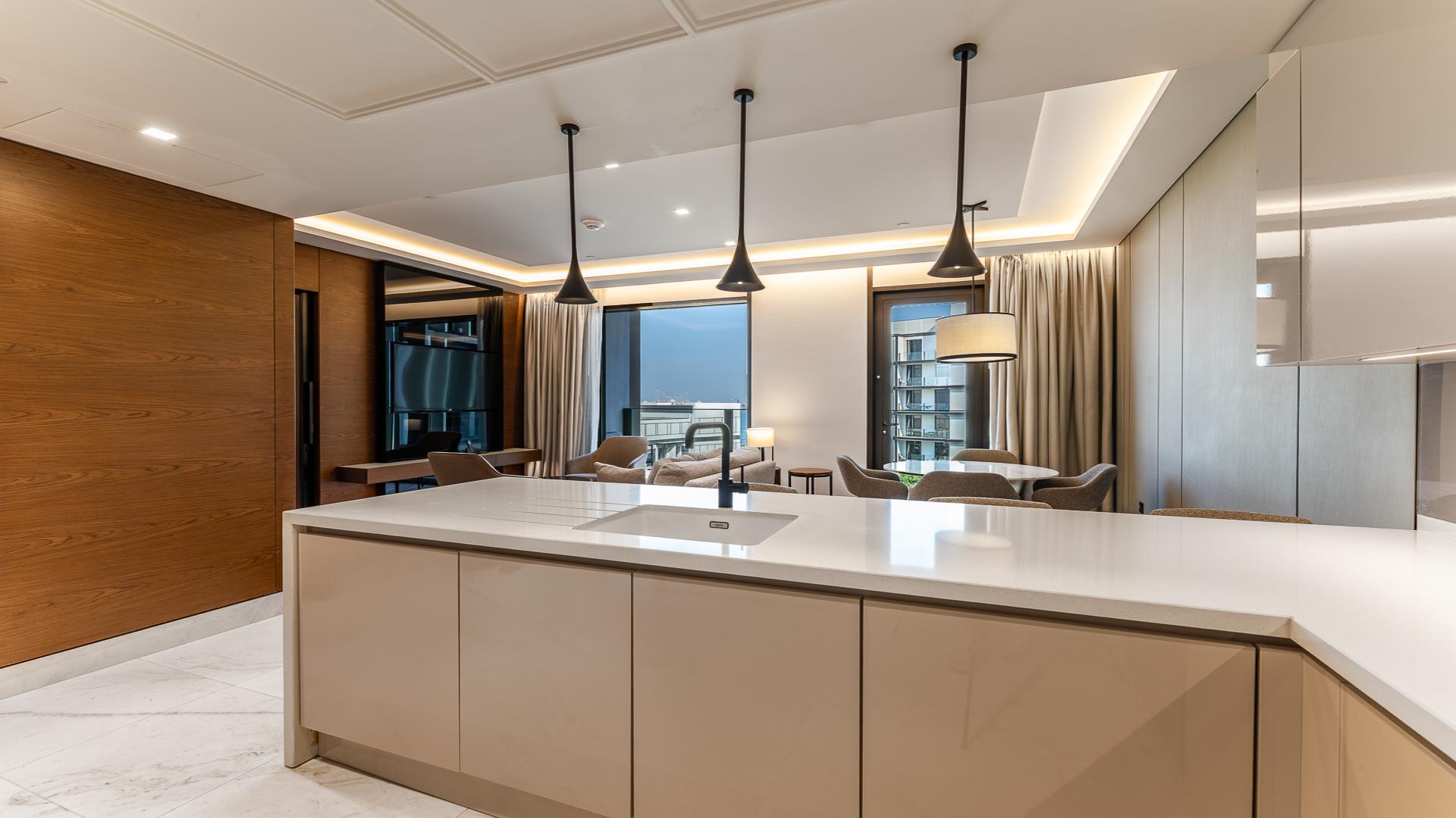 Modern living room in Bluewaters apartment, featuring stylish furniture and large windows