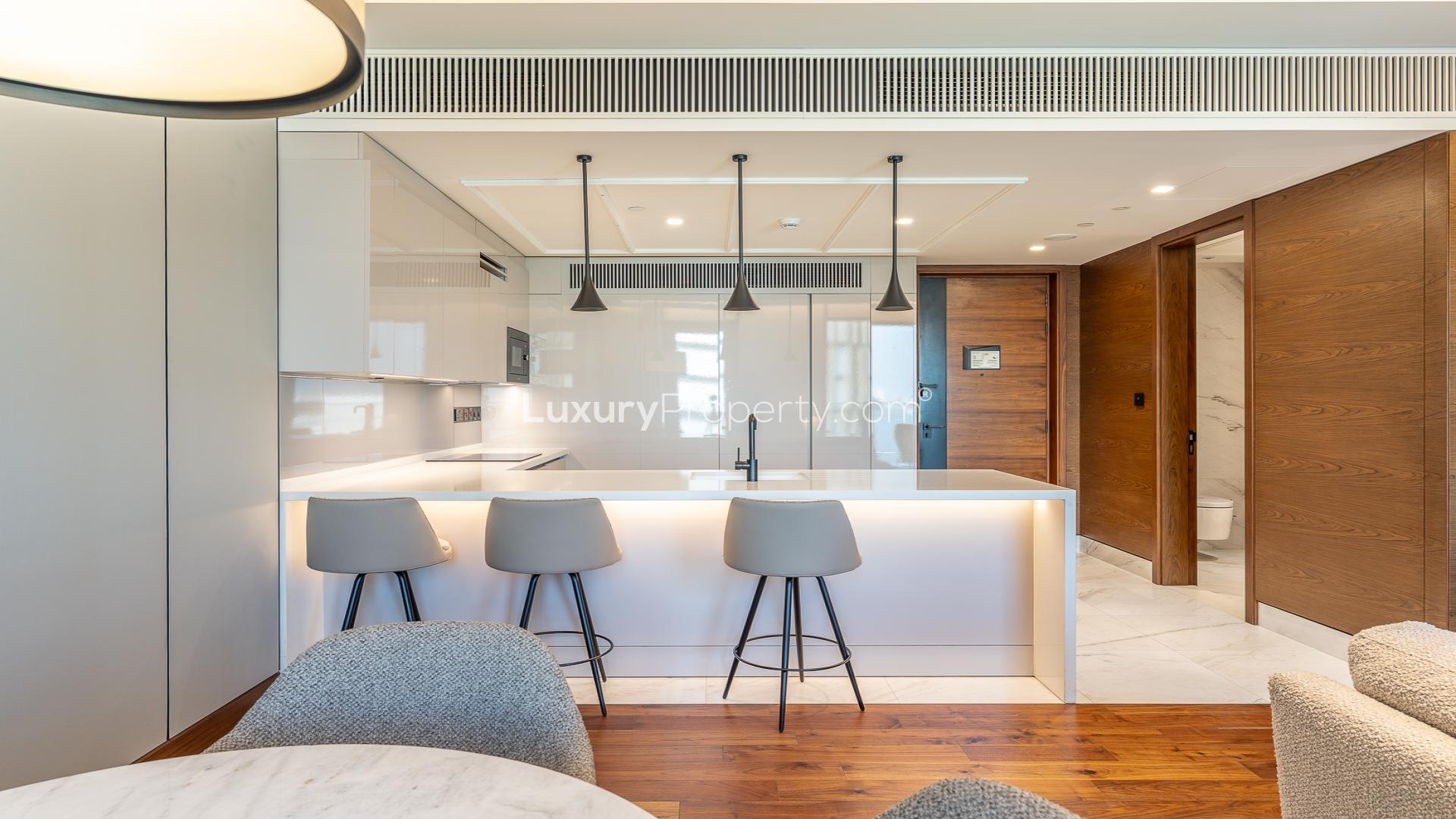 Modern kitchen and living area in Bluewaters apartment, Caesars Bluewaters Dubai, for rent