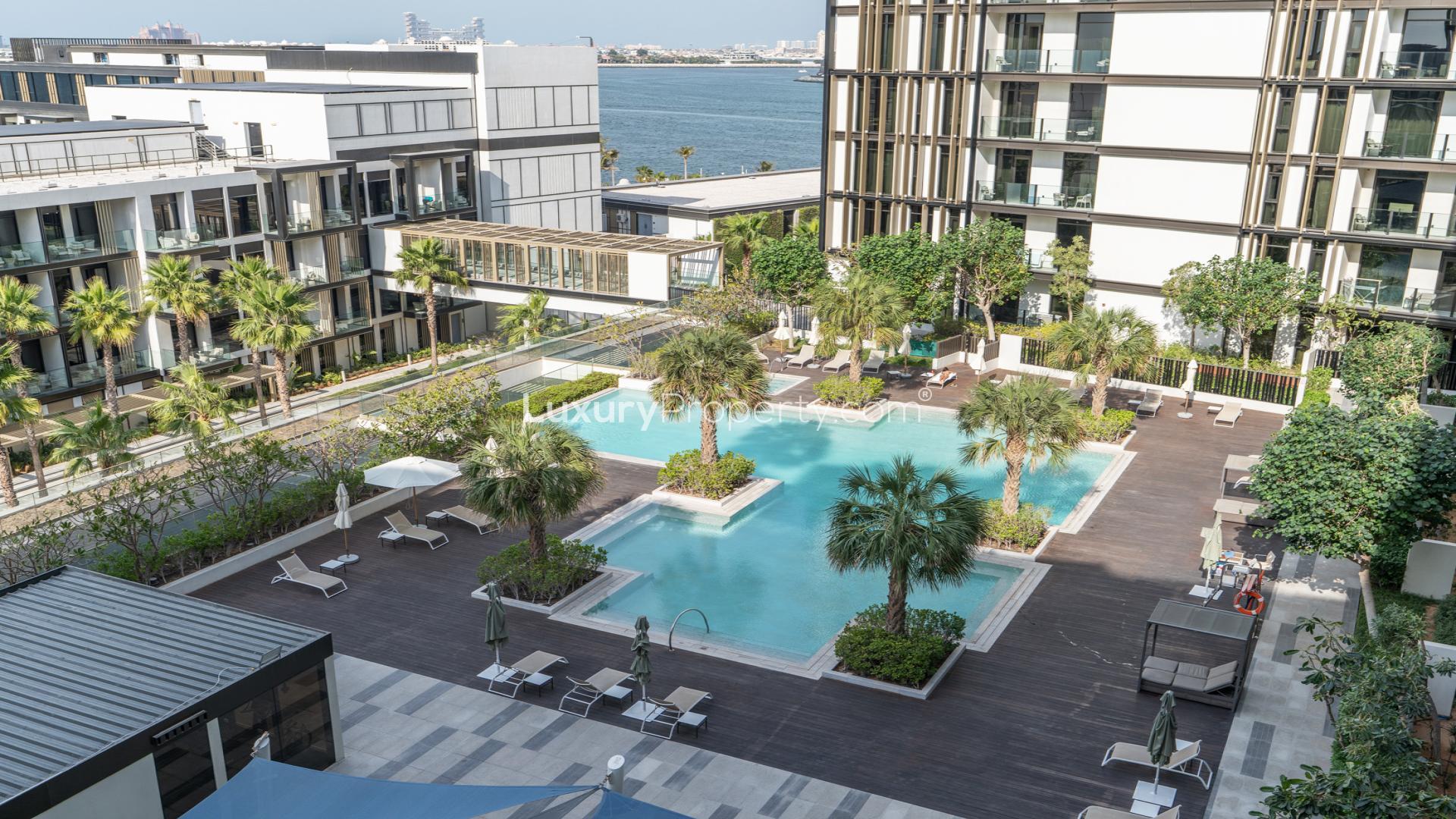 Modern living room in Caesars Bluewaters Dubai apartment with sleek furnishings and wood accents