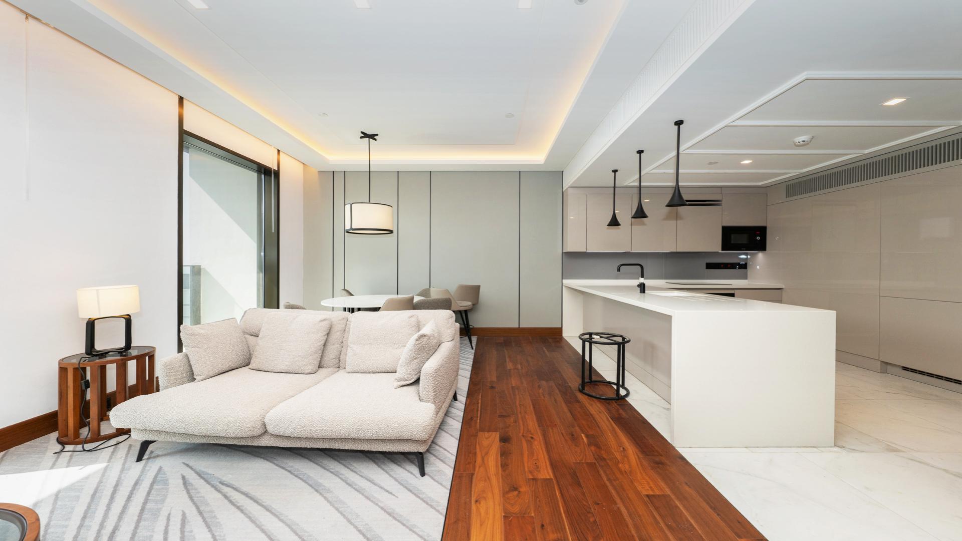 Modern living area in Caesars Bluewaters Dubai apartment for rent, featuring stylish furnishings