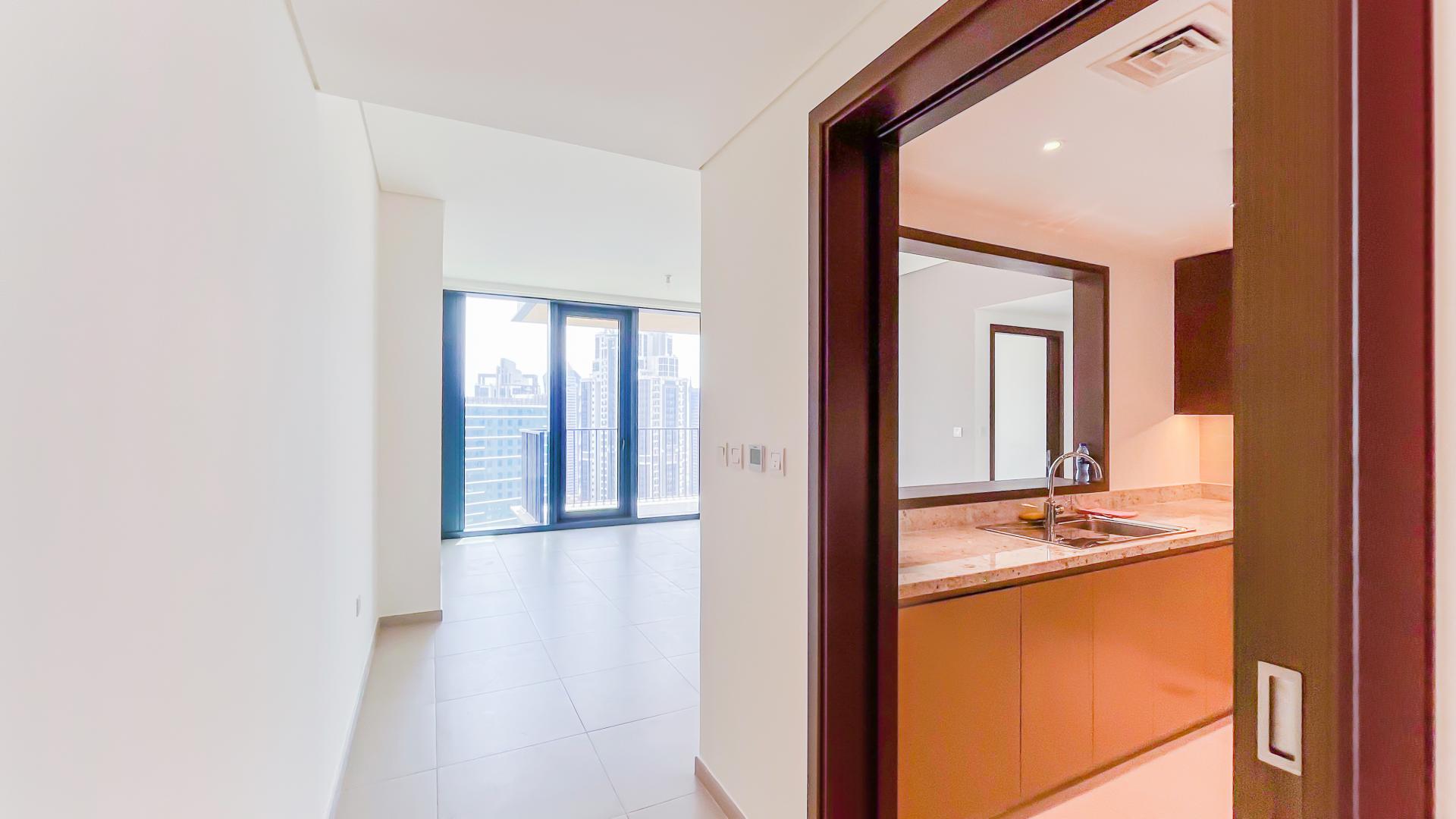 Bright living area with floor-to-ceiling windows and city views in Downtown Dubai apartment