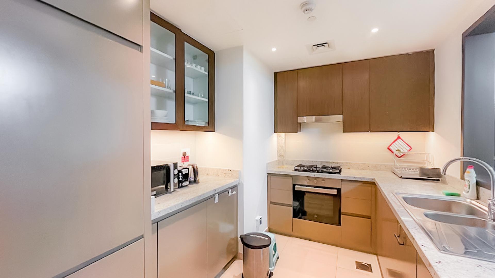 Fully furnished living room with balcony view in BLVD Heights, Downtown Dubai apartment