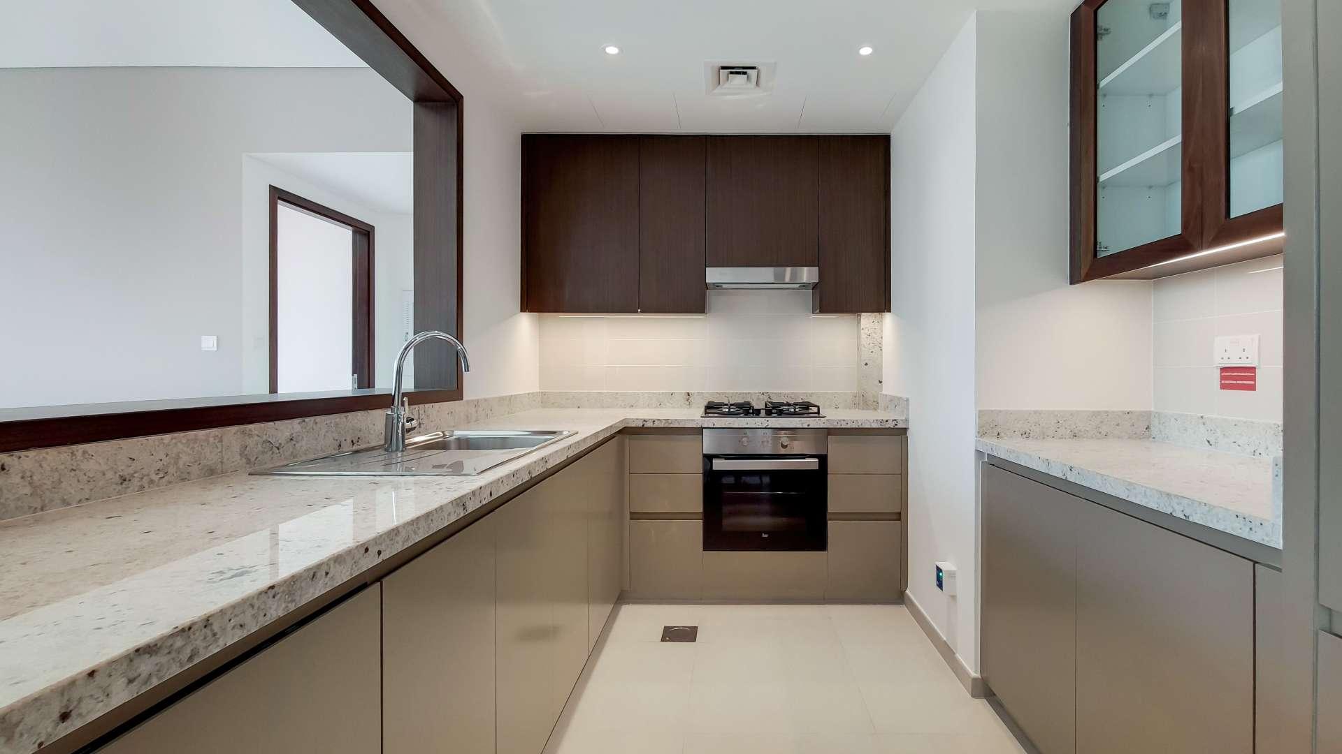 Modern kitchen in 1-bedroom apartment, BLVD Heights, Downtown Dubai, with sleek countertops and cabinets