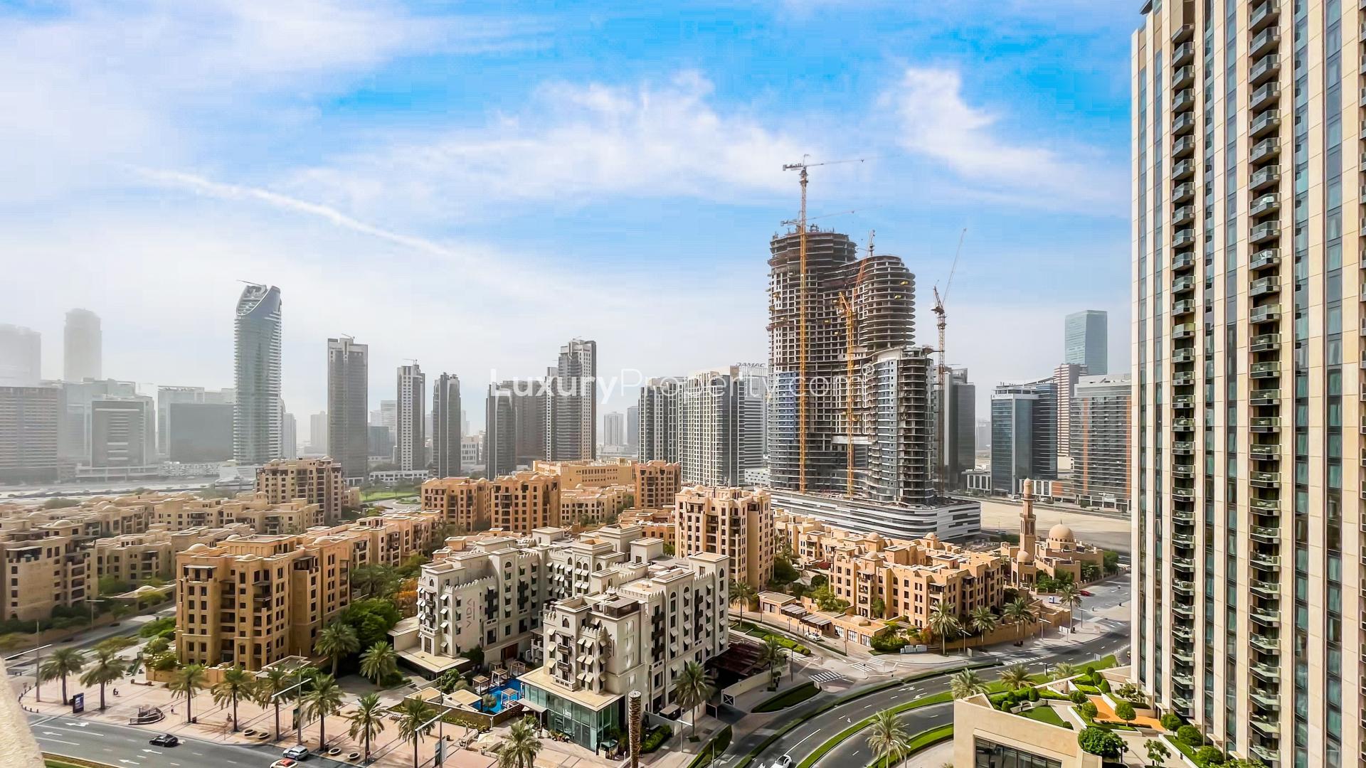 Upgraded 1-bedroom furnished apartment living area with city view in Downtown Dubai